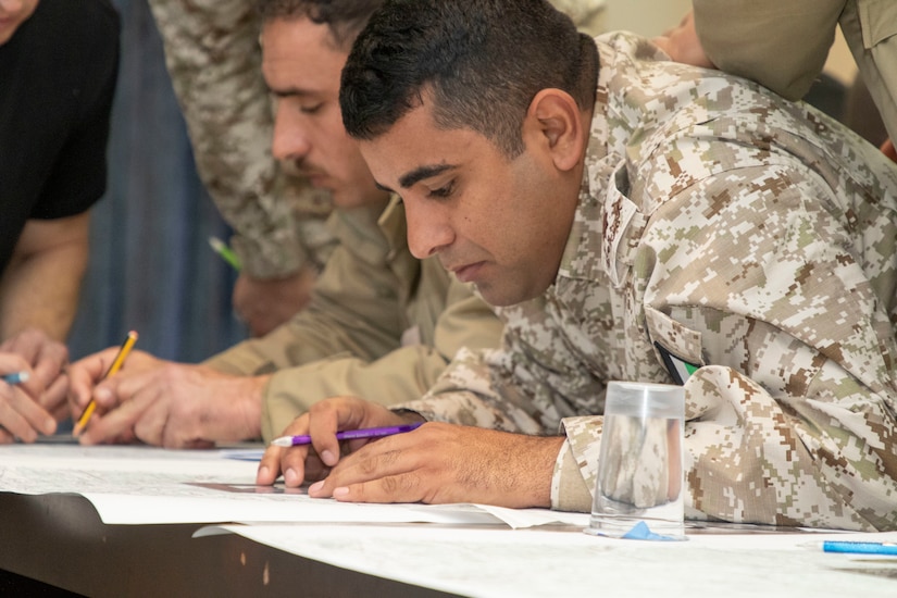 Jordan Armed Forces-Arab Army (JAF) Soldiers use map protractors to plot points during a Map Reading Subject Matter Expert Exchange with Military Engagement Team-Jordan, 158th Maneuver Enhancement Brigade, Arizona Army National Guard, at a base outside of Amman, Jordan Jan. 13, 2020. The United States will protect our people and interests anywhere they are found around the world and is committed to the security of Jordan and to the partnering closely with the JAF to meet common security challenges. (U.S. Army photo by Sgt. 1st Class Shaiyla B. Hakeem)