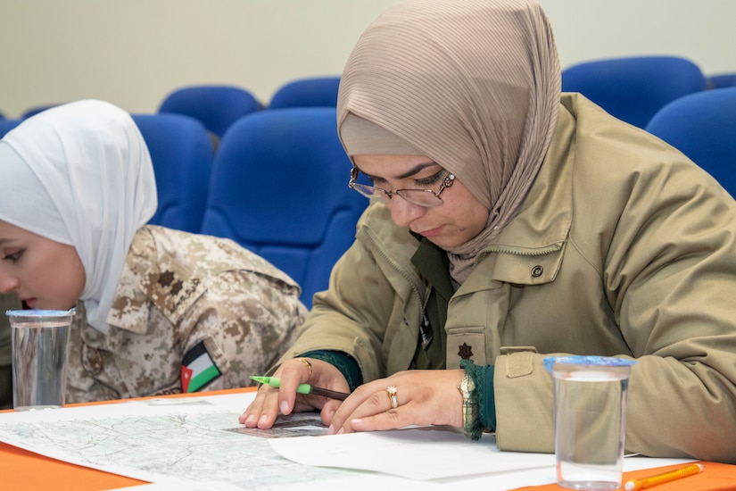 A Jordan Armed Forces-Arab Army (JAF) Quick Reaction Force Female Engagement Team Soldier use a map protractor to plot points during a Map Reading Subject Matter Expert Exchange with Military Engagement Team-Jordan, 158th Maneuver Enhancement Brigade, Arizona Army National Guard, at a base outside of Amman, Jordan Jan. 13, 2020. The United States will protect our people and interests anywhere they are found around the world and is committed to the security of Jordan and to the partnering closely with the JAF to meet common security challenges. (U.S. Army photo by Sgt. 1st Class Shaiyla B. Hakeem)