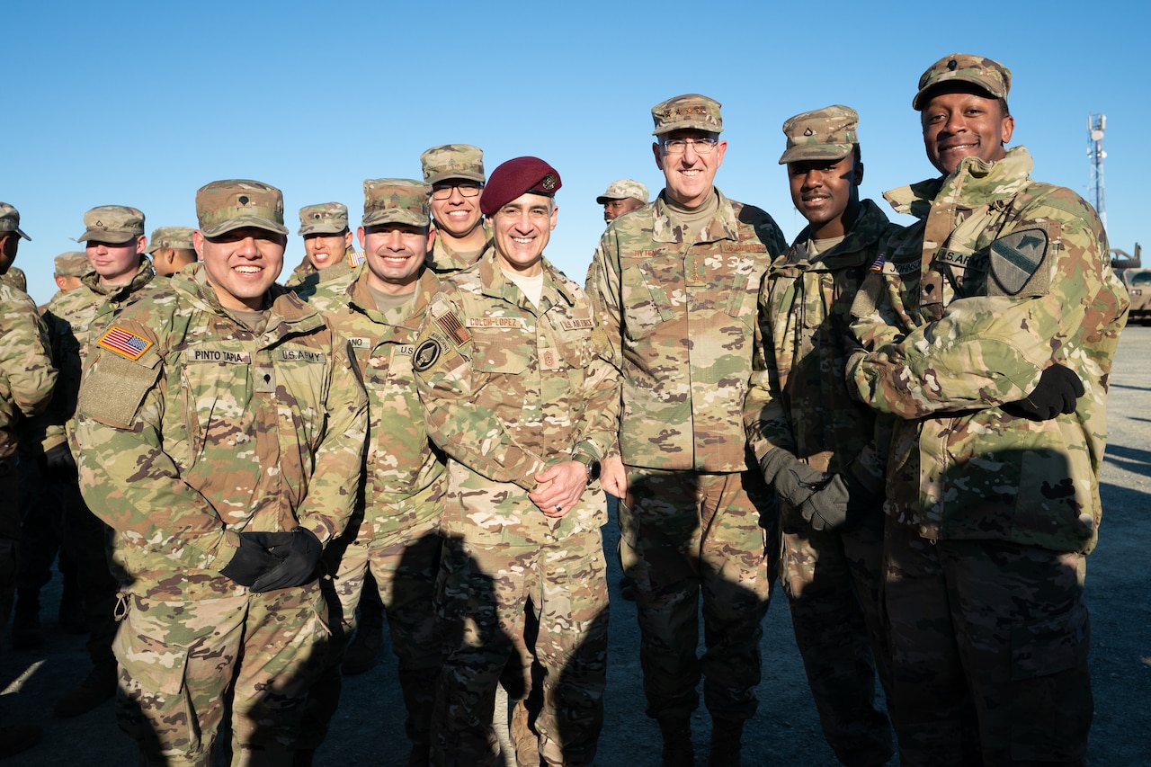 Group of men take a photo.