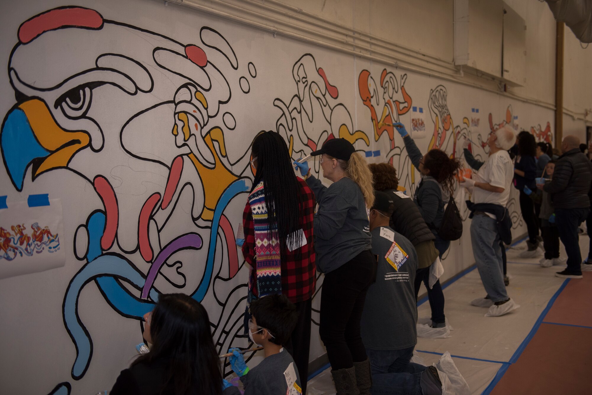 Rebuilding Together Solano County volunteers paint a mural during a Martin Luther King Jr. Day of Service volunteer event Jan. 20, 2020, at Fairfield High School, Fairfield, California. The Rebuilding Together Solano County organization hosts an annual Martin Luther King Jr. Day of Service event where various volunteers help rebuild the community. This year marked their 11th annual Martin Luther King Jr. Day of Service event. More than 300 workers, including 31 Travis Airmen, volunteered to make their community a better and safer place. (U.S. Air Force photo by Airman 1st Class Cameron Otte)