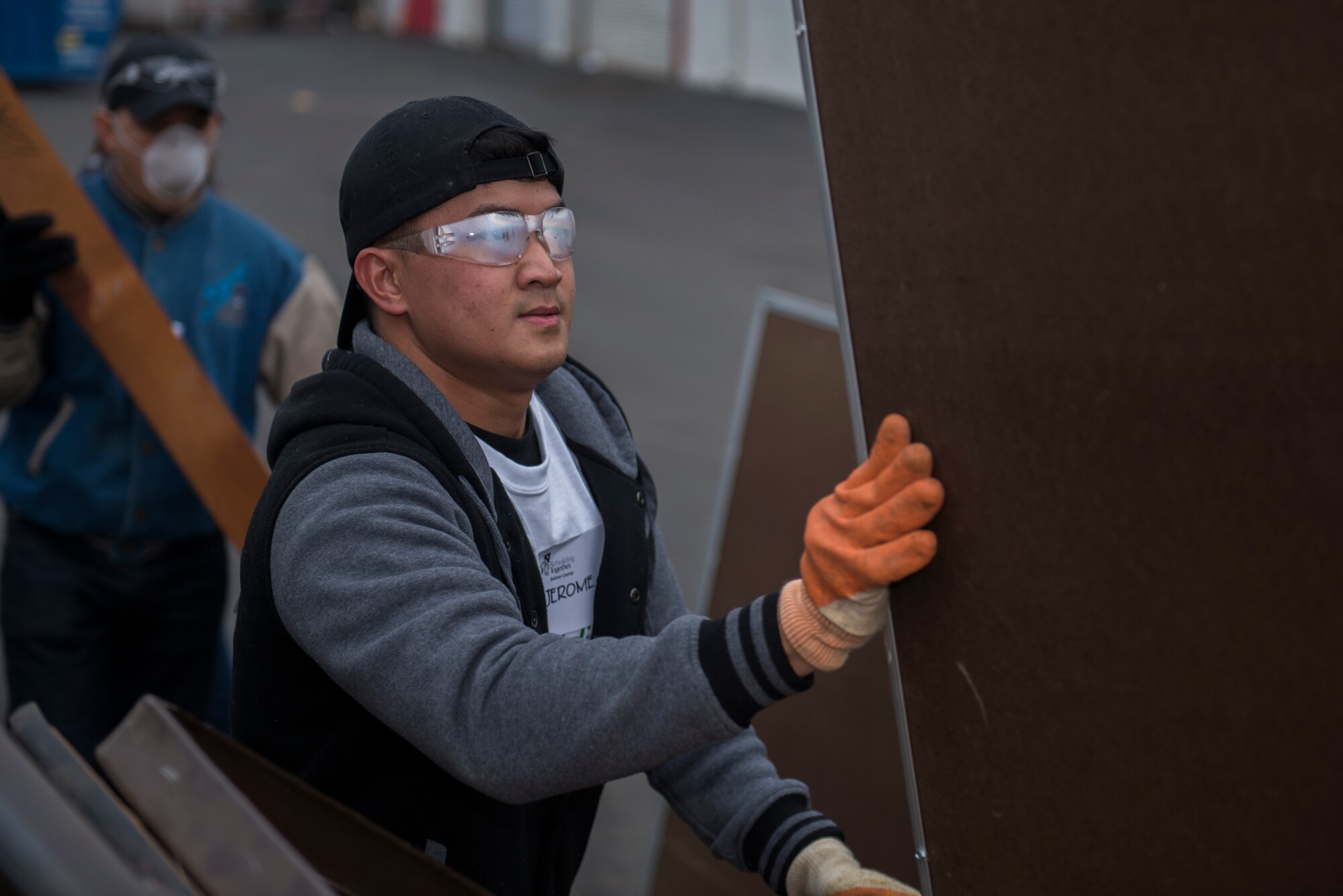 U.S. Air Force Airman 1st Class Jerome Rivera, 60th Diagnostics and Therapeutics Squadron medical lab technician, carries old and damaged items to a dumpster during a Martin Luther King Jr. Day of Service volunteer event Jan. 20, 2020, at Fairfield High School, Fairfield, California. The Rebuilding Together Solano County organization hosts an annual Martin Luther King Jr. Day of Service event where various volunteers help rebuild the community. This year marked their 11th annual Martin Luther King Jr. Day of Service event. More than 300 workers, including 31 Travis Airmen, volunteered to make their community a better and safer place.  (U.S. Air Force photo by Airman 1st Class Cameron Otte)