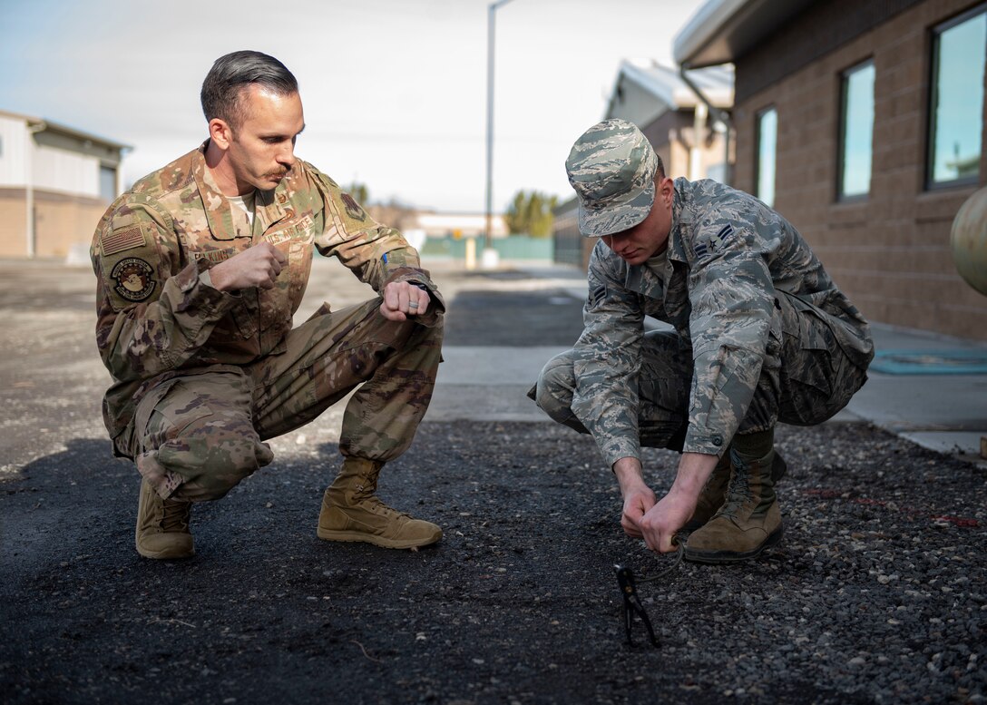 Staff Sgt. David Felkins, 366th Civil Engineer Squadron explosives ordinance disposal technician, teaches an Airman how to conduct a time fuse burn test, Jan. 23, 2020, at Mountain Home Air Force Base, Idaho. These fuses are used by explosive ordinance disposal technicians to build counter-detonation explosives downrange. (U.S. Air Force photo by Senior Airman Tyrell Hall)