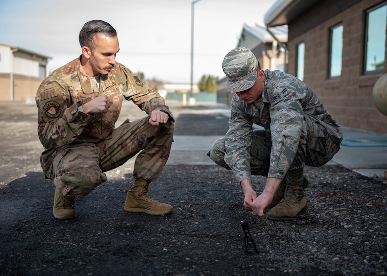 Staff Sgt. David Felkins, 366th Civil Engineer Squadron explosives ordinance disposal technician, teaches an Airman how to conduct a time fuse burn test, Jan. 23, 2020, at Mountain Home Air Force Base, Idaho. These fuses are used by explosive ordinance disposal technicians to build counter-detonation explosives downrange. (U.S. Air Force photo by Senior Airman Tyrell Hall)