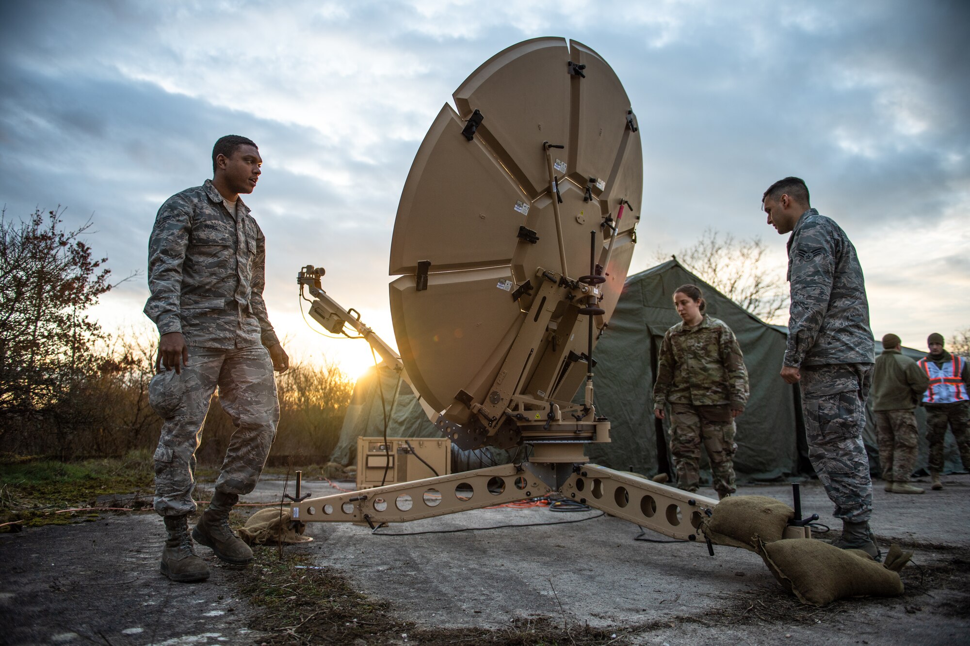 U.S. Airmen assigned to the 1st Combat Communications Squadron adjust a satellite dish during exercise Heavy Rain in Grostenquin, France, Jan. 15, 2020. The 1st CBCS technicians provided the 435th Security Forces Squadron with electronic warfare scenarios to bolster their capabilities in a contested communications environment while sharpening their own skills on spectrum interference. (U.S. Air Force photo by Staff Sgt. Devin Boyer)