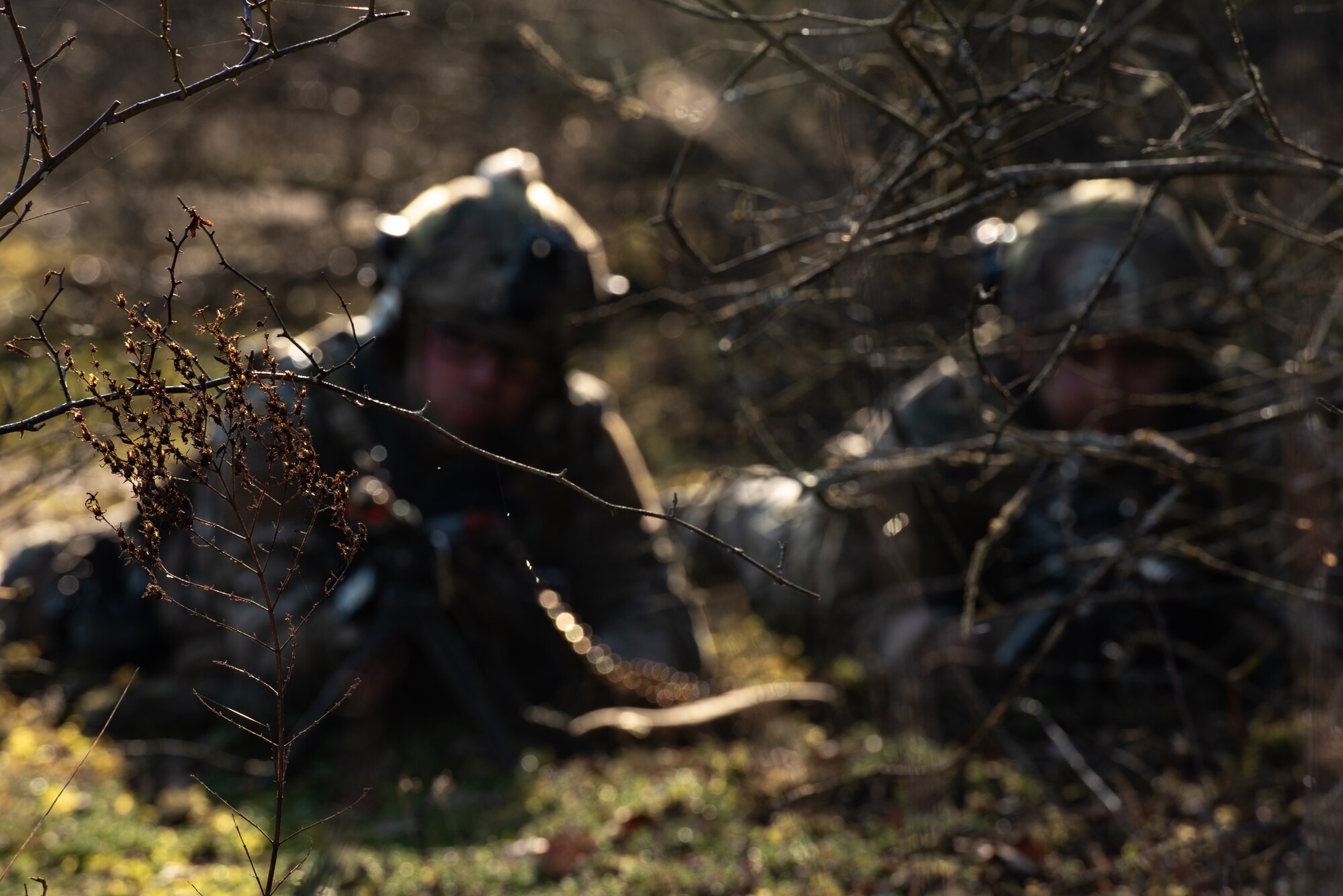 U.S. Airmen assigned to the 435th Security Forces Squadron pull security behind foliage during exercise Frozen Defender in Grostenquin, France, Jan. 16, 2020. The Defenders used the terrain to their advantage when dealing with opposition forces in the area. (U.S. Air Force photo by Staff Sgt. Devin Boyer)