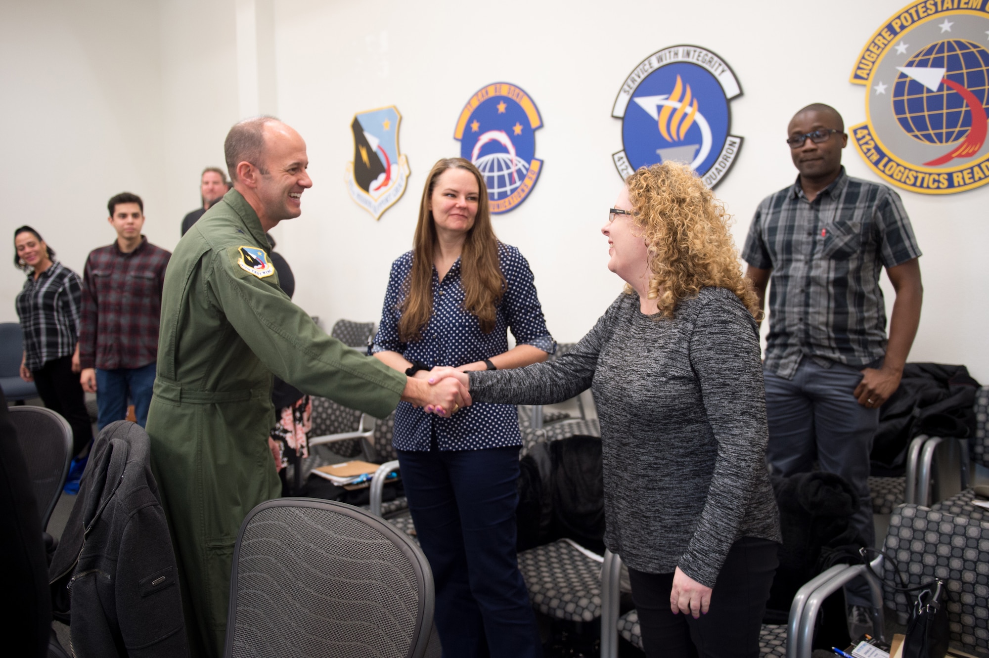 Brig. Gen. E. John Teichert, 412th Test Wing Commander, welcomes newly-hired Air Force Civilian, Joy Stanton to Team Edwards during a civilian new employee orientation event at Edwards Air Force Base, California, Jan. 6, 2020. (U.S. Air Force photo by Richard Gonzales)