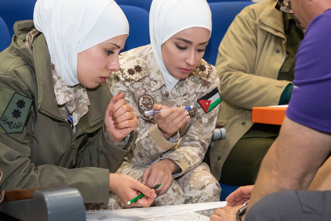 A U.S. Army Soldier, with Military Engagement Team-Jordan, 158th Maneuver Enhancement Brigade, Arizona Army National Guard, locates map grid coordinates with Jordan Armed Forces-Arab Army (JAF) Quick Reaction Force Female Engagement Team Soldiers during a Map Reading Subject Matter Expert Exchange at a base outside of Amman, Jordan Jan. 13, 2020. The United States is committed to the security of Jordan and to partnering closely with the JAF to meet common security challenges. (U.S. Army photo by Sgt. 1st Class Shaiyla B. Hakeem)