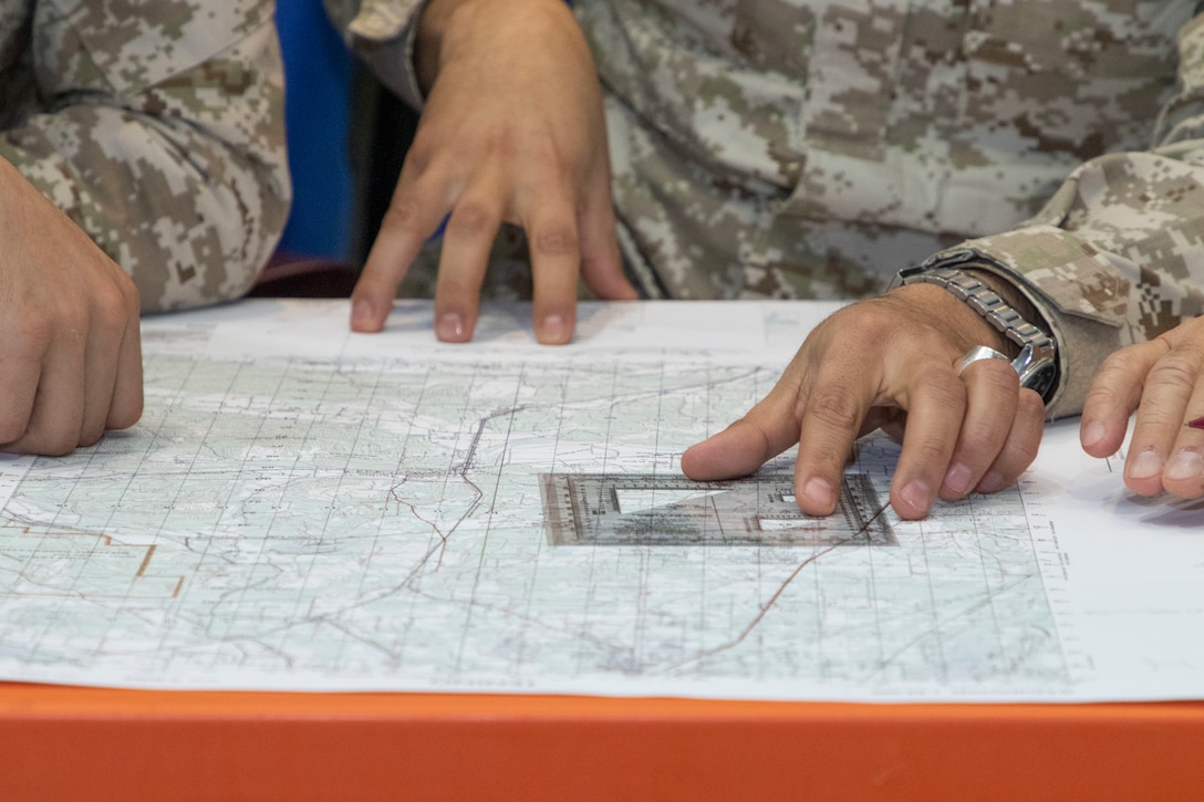 Jordan Armed Forces-Arab Army (JAF) Soldiers use a map protractor to plot points during a Map Reading Subject Matter Expert Exchange with Military Engagement Team-Jordan, 158th Maneuver Enhancement Brigade, Arizona Army National Guard, at a base outside of Amman, Jordan Jan. 13, 2020. The United States will protect our people and interests anywhere they are found around the world and is committed to the security of Jordan and to the partnering closely with the JAF to meet common security challenges. (U.S. Army photo by Sgt. 1st Class Shaiyla B. Hakeem)