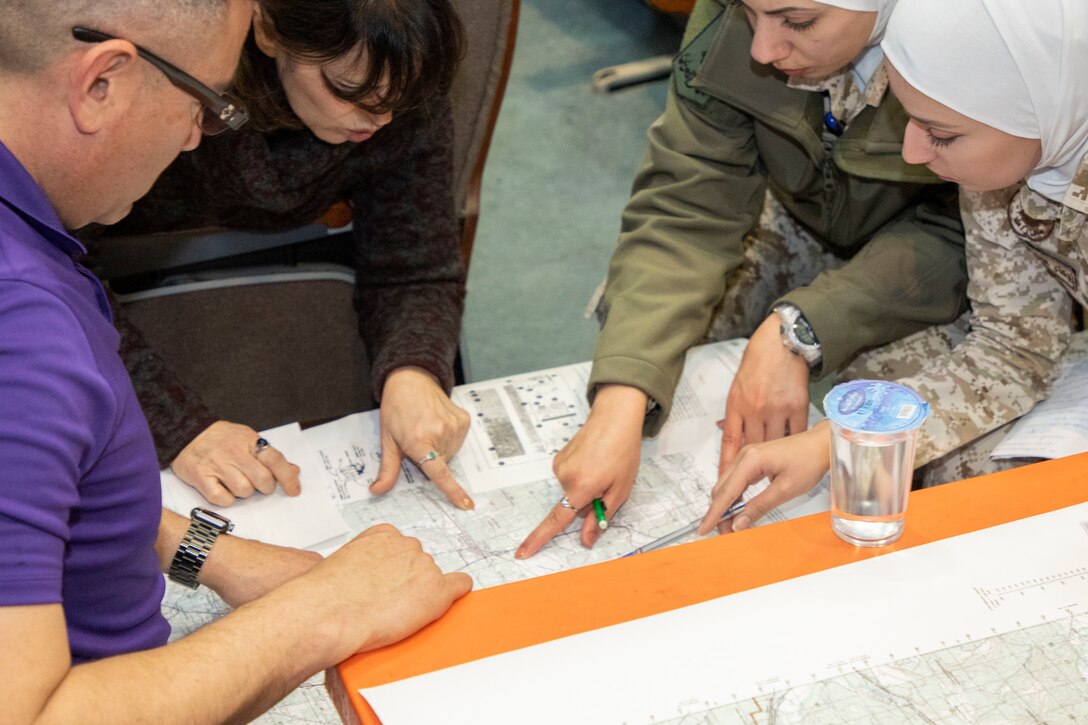 A U.S. Army Soldier (left), with Military Engagement Team-Jordan, 158th Maneuver Enhancement Brigade, Arizona Army National Guard, plots points on a map with Jordan Armed Forces-Arab Army (JAF) Quick Reaction Force Female Engagement Team members during a Map Reading Subject Matter Expert Exchange at a base outside of Amman, Jordan Jan. 13, 2020. The United States will protect our people and interests anywhere they are found around the world and is committed to the security of Jordan and to the partnering closely with the JAF to meet common security challenges. (U.S. Army photo by Sgt. 1st Class Shaiyla B. Hakeem)