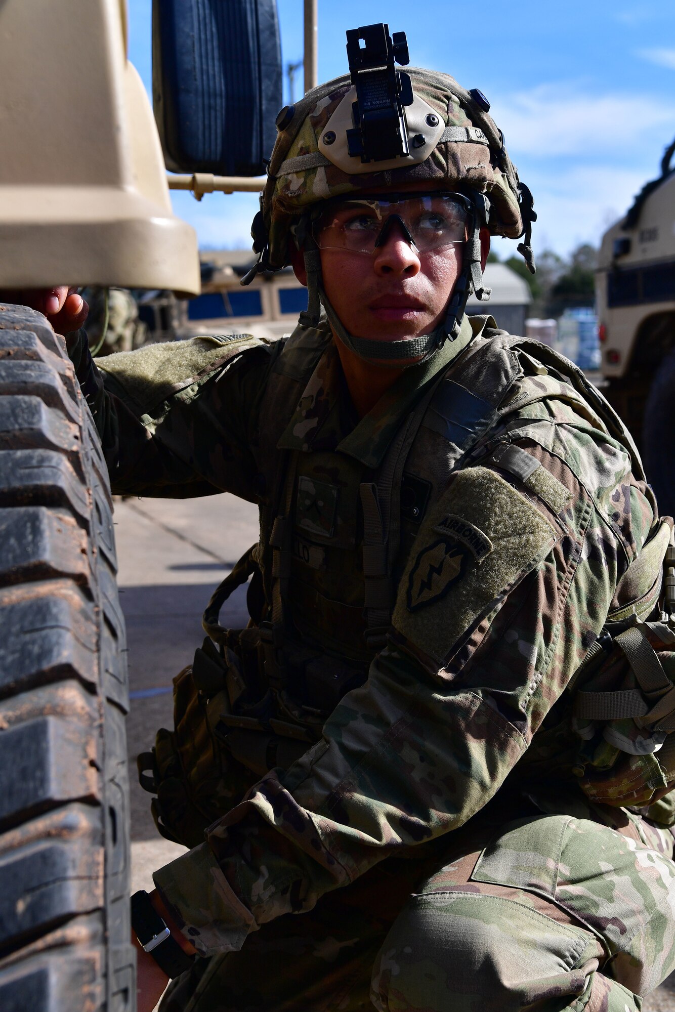 A soldier from the 4th Brigade Combat Team (Airborne), 25th Infantry Division, at Joint Base Elmendorf-Richardson, Alaska, checks the tire pressure on a Humvee during Green Flag Little Rock 20-03.