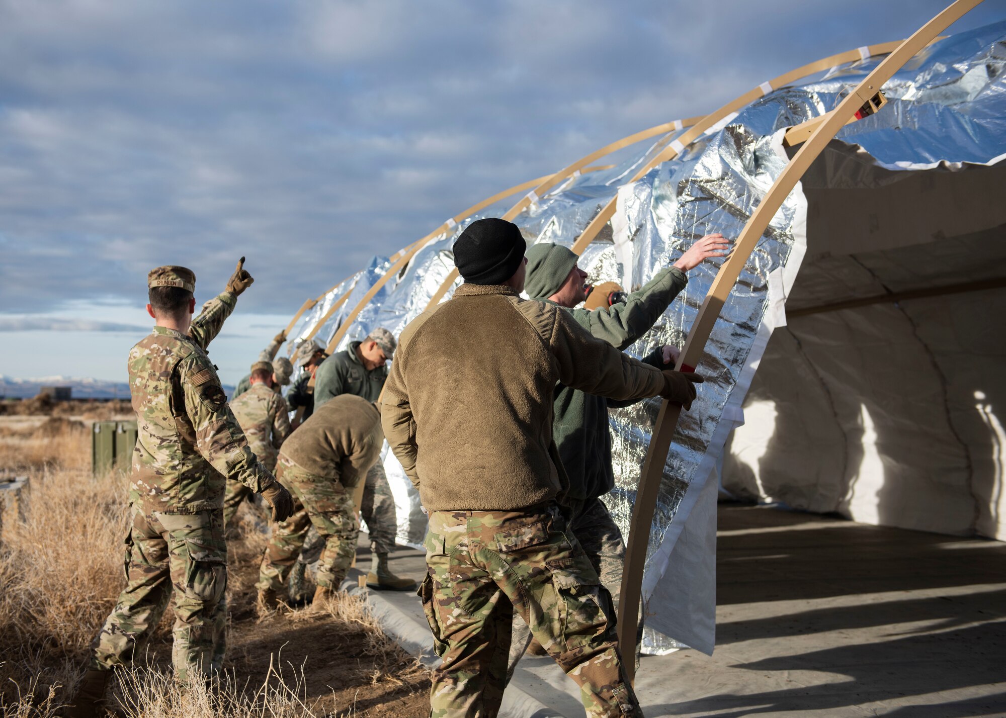 Airman from the 366th Civil Engineer Squadron use teamwork to construct a tactical shelter during the Base Emergency Engineer Force training, Jan. 23, 2020, at Mountain Home Air Force Base, Idaho. This training was conducted to equip Airman with skills from other career fields to enhance their readiness. (U.S. Air Force photo by Senior Airman Tyrell Hall