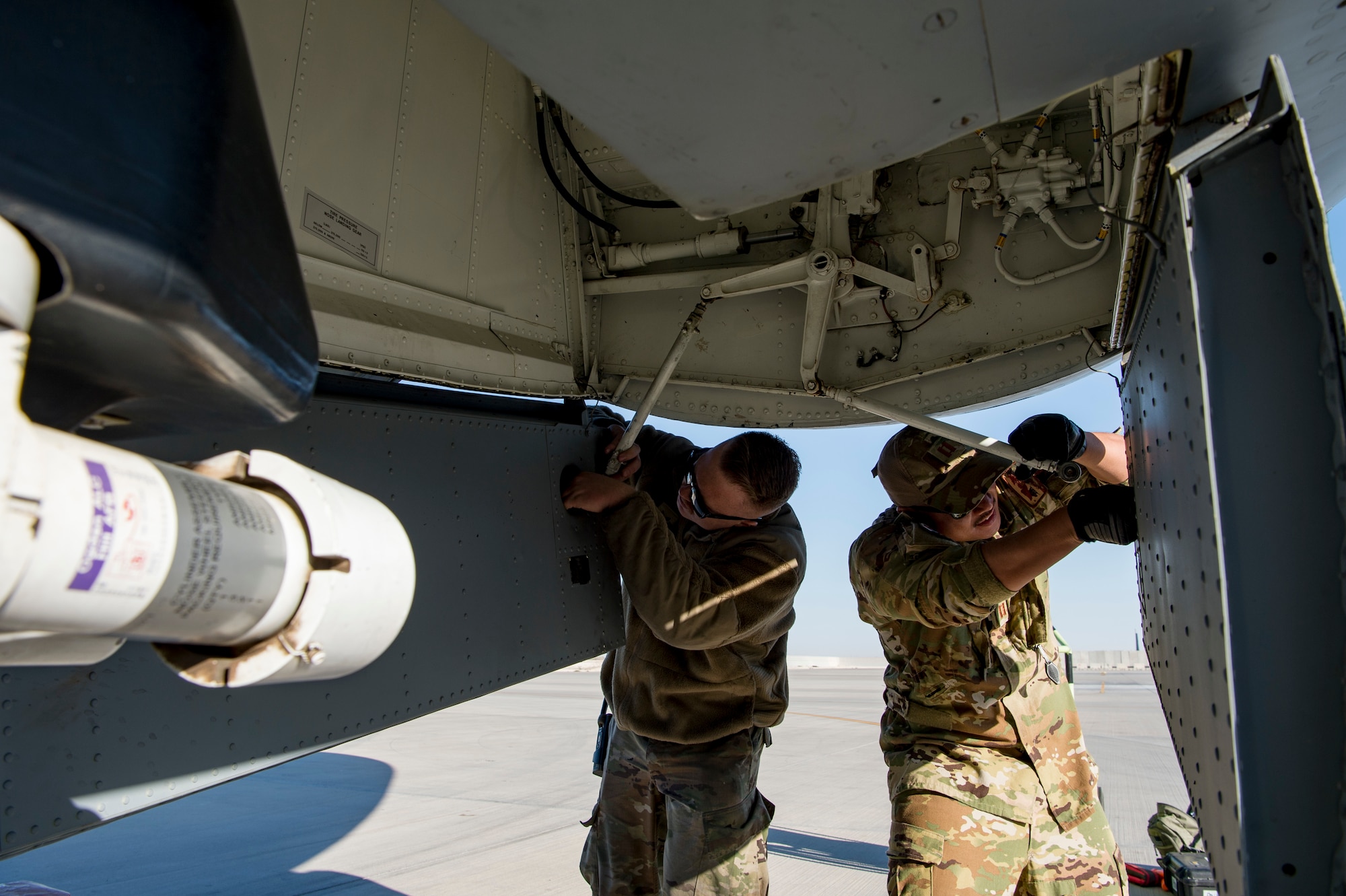 A U.S. Air Force pilot assigned to the 28th Expeditionary Air Refueling Squadron, right, and a U.S. Air Force crew chief assigned to the 385th Expeditionary Aircraft Maintenance perform a preflight inspection on a KC-135 Stratotanker at Al Udeid Air Base, Qatar, Jan. 14, 2020.