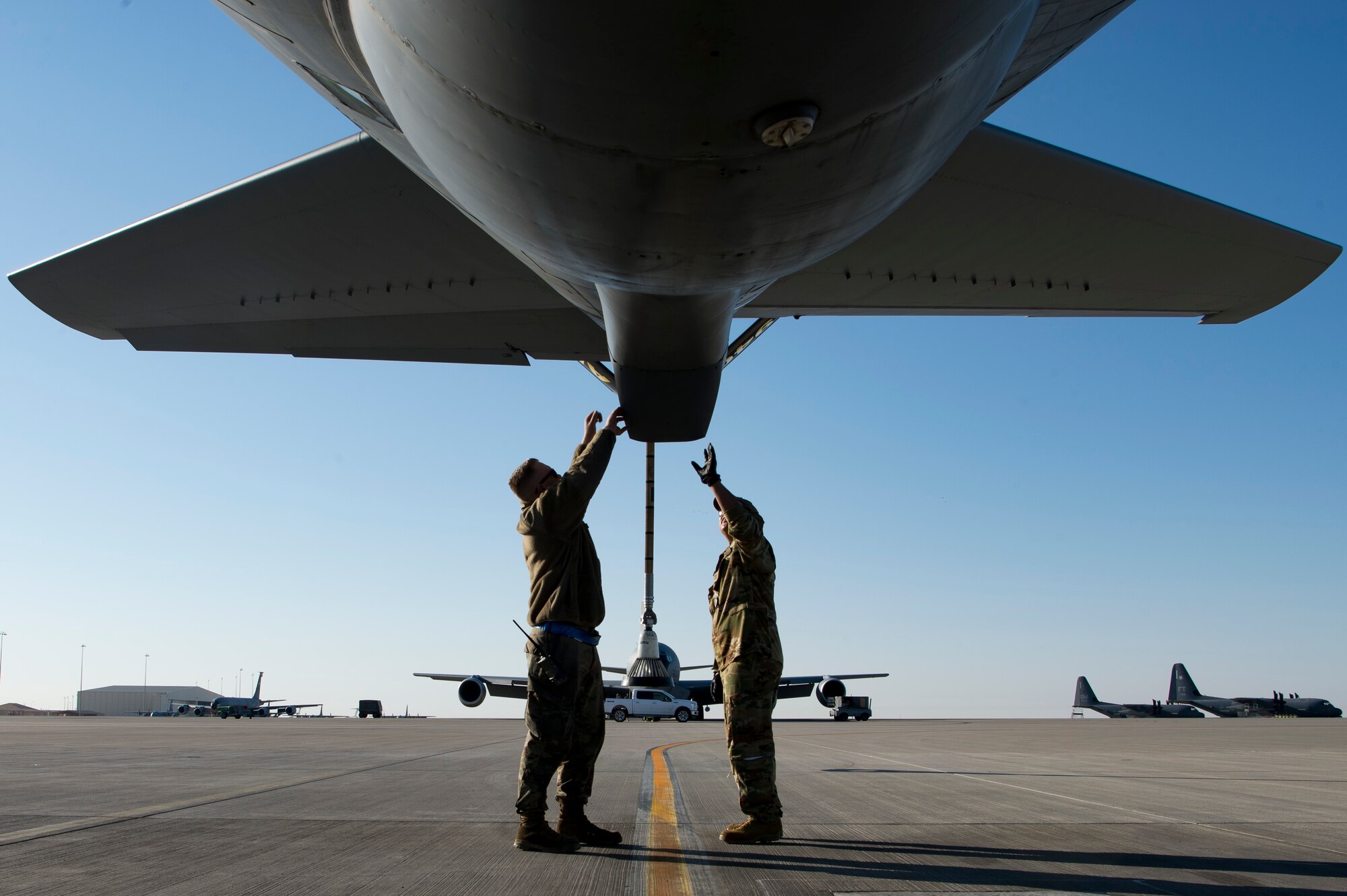 A U.S. Air Force pilot assigned to the 28th Expeditionary Air Refueling Squadron, right, and a U.S. Air Force crew chief assigned to the 385th Expeditionary Aircraft Maintenance perform a preflight inspection on a KC-135 Stratotanker at Al Udeid Air Base, Qatar, Jan. 14, 2020.