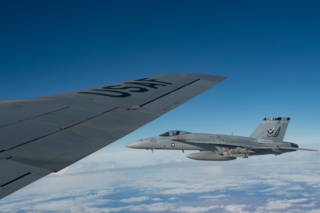 A U.S. Navy F/A-18 Super Hornet flies alongside a KC-135 Stratotanker assigned to the 28th Expeditionary Air Refueling Squadron over Afghanistan, Jan. 14, 2020.
