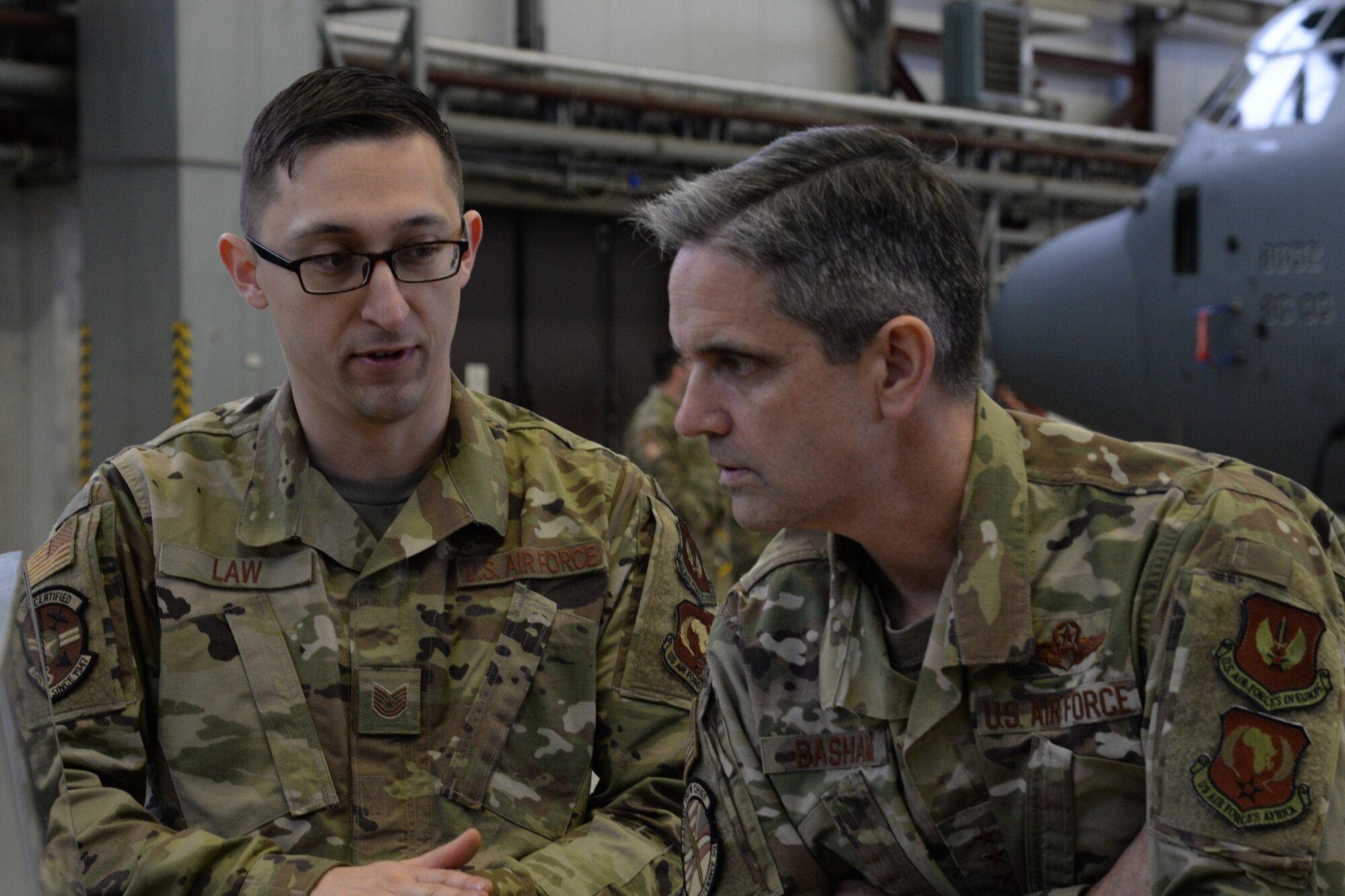 U.S. Air Force Lt. Gen. Steven Basham, U.S. Air Forces in Europe-Air Forces Africa deputy commander, right, examines a photo chart presented by Tech. Sgt. Jacob Law 86th Maintenance Squadron crash recovery NCO in charge, Jan. 17, 2020. Law spoke about past crash recovery operations and demonstrated pneumatic lift bags used to lift heavy equipment in recovery situations. (U.S. Air Force  photo by Airman 1st Class Daniel Sanchez)