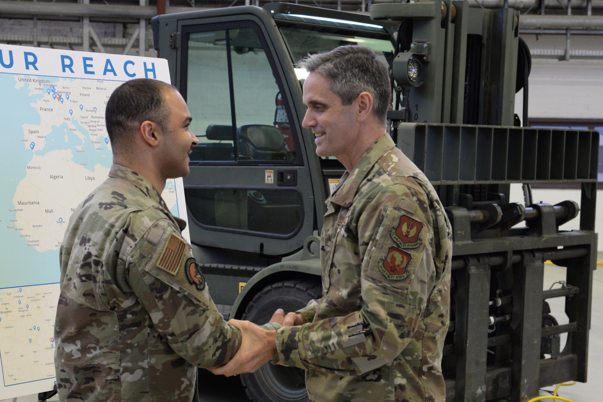 U.S. Air Force Lt. Gen. Steven Basham, U.S. Air Forces in Europe-Air Forces Africa deputy commander, right, coins Senior Airman Jerome Budde, 86th Maintenance Squadron physical dimension section technician, for exemplary work within his group during an immersion tour on Ramstein Air Base, Jan. 17, 2020. Budde explained the reach of the precision measurement equipment laboratory on base, and how they service 39 locations and over 300 work centers spread throughout Europe and Africa. (U.S. Air Force photo by Airman 1st Class Daniel Sanchez)