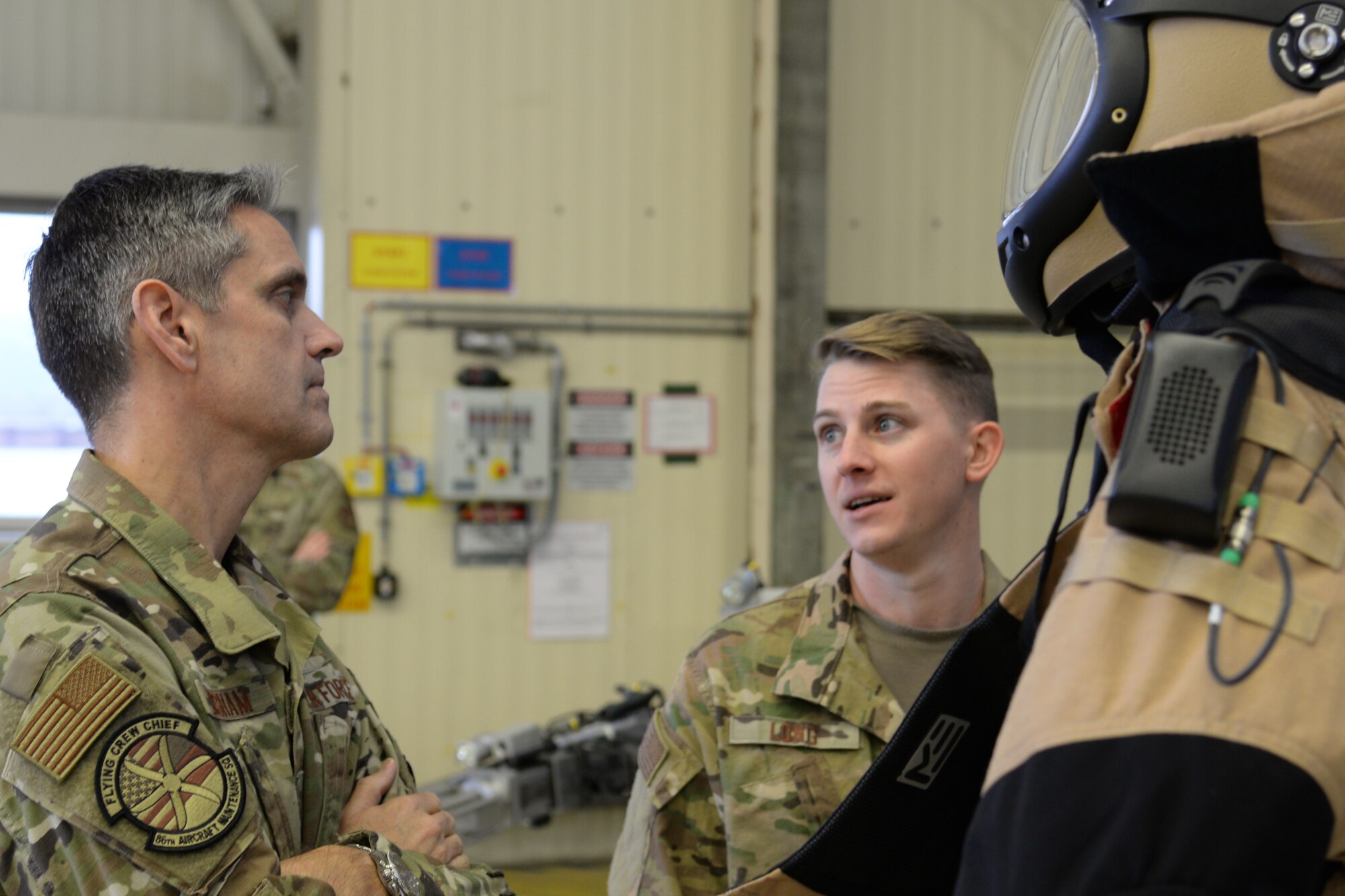 U.S. Air Force Lt. Gen. Steven Basham, U.S. Air Forces in Europe-Air Forces Africa deputy commander, left, connects with Staff Sgt. Michael Long, 786th Civil Engineer Squadron explosive ordnance disposal craftsman, in a hangar during a base tour of Ramstein on Jan. 17, 2020. Long showed Basham some of the latest gear used by the EOD team and shared some of the history behind the equipment. (U.S. Air Force photo by Airman 1st Class Daniel Sanchez)