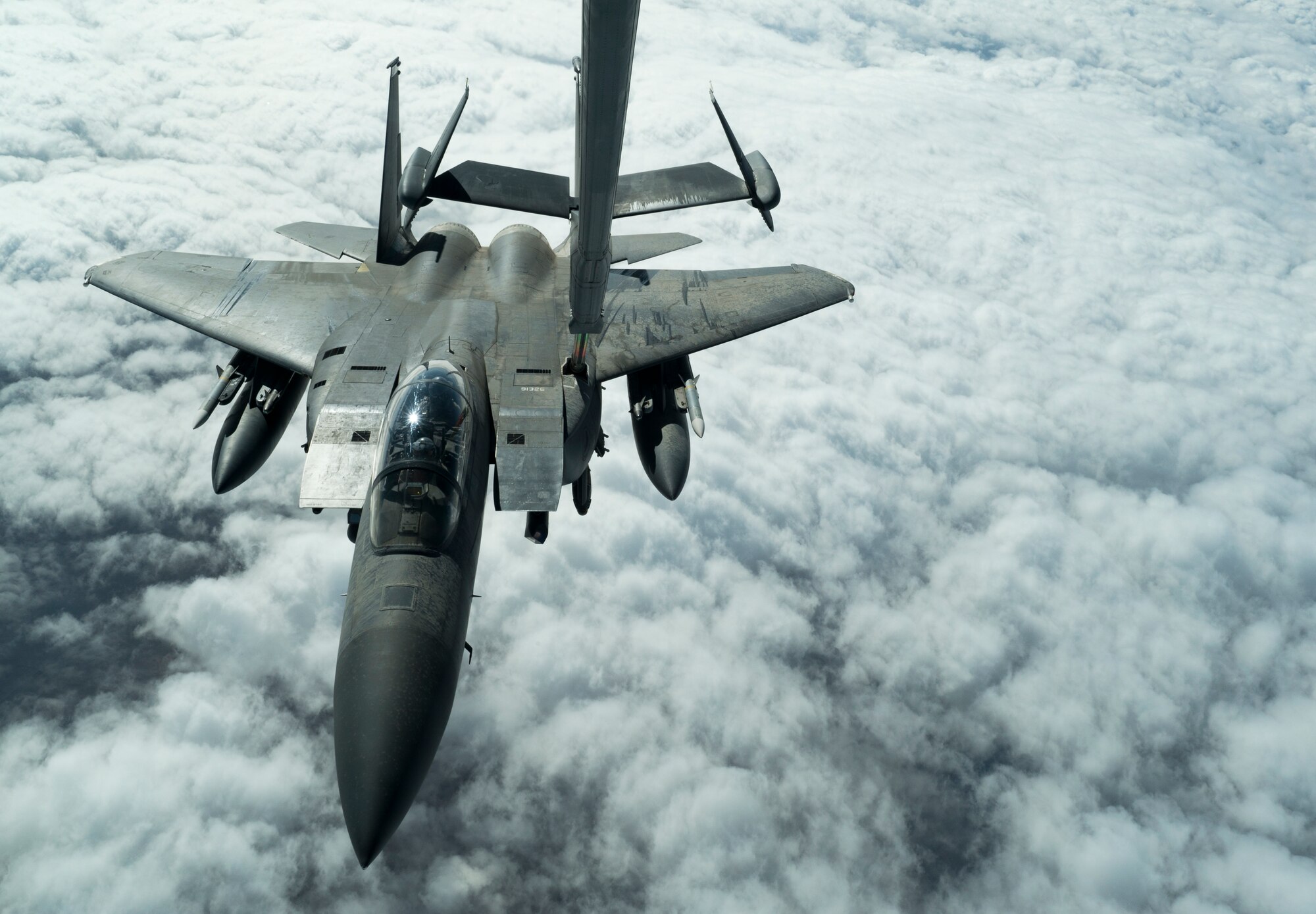 A U.S. Air Force F-15E Strike Eagle aircraft assigned to the 494th Expeditionary Fighter Squadron receives fuel from a KC-10 Extender aircraft assigned to the 908th Expeditionary Air Refueling Squadron over an undisclosed location, Jan. 13, 2020.