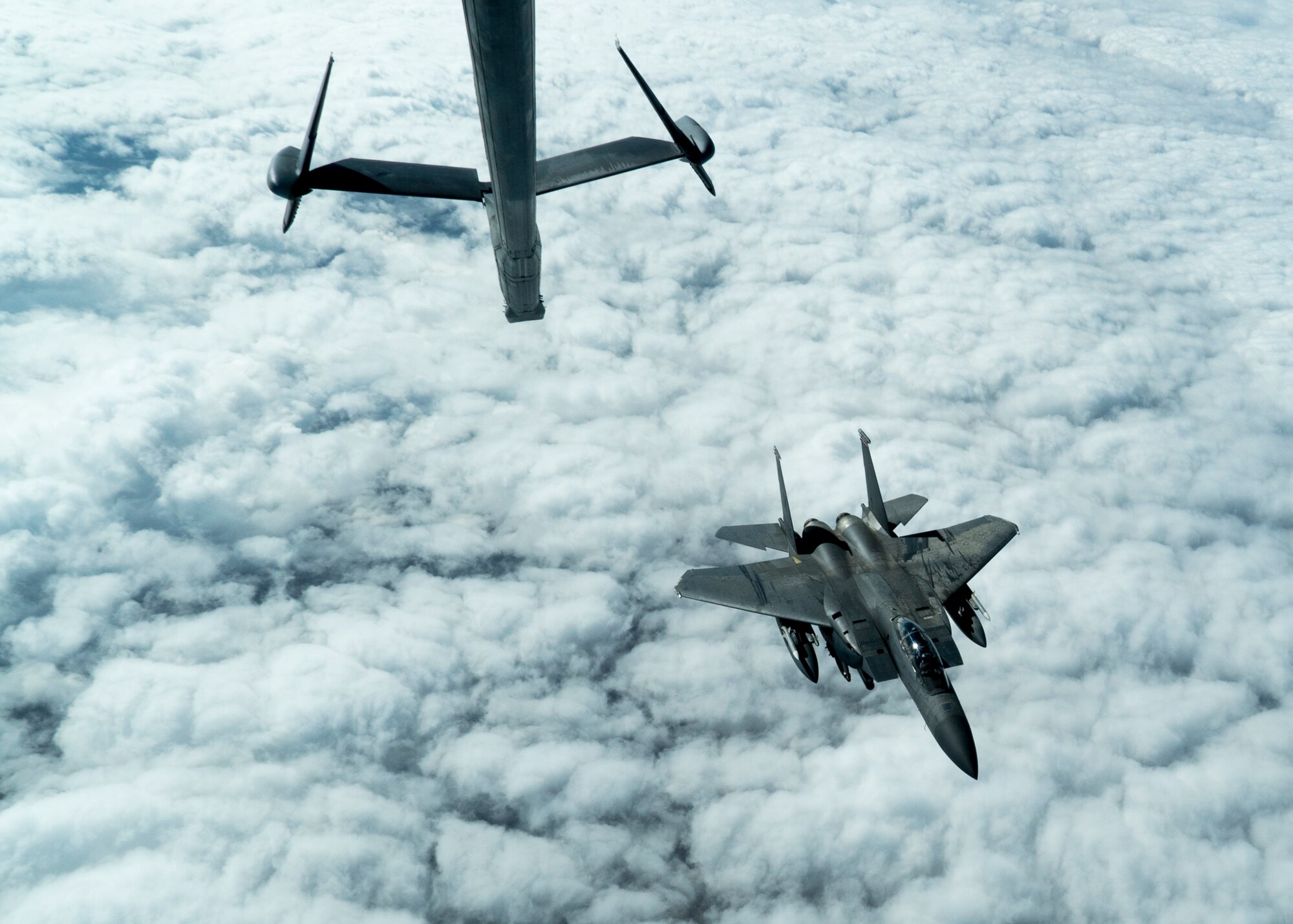 A U.S. Air Force F-15E Strike Eagle aircraft assigned to the 494th Expeditionary Fighter Squadron pulls away from a KC-10 Extender aircraft assigned to the 908th Expeditionary Air Refueling Squadron over an undisclosed location, Jan. 13, 2020.