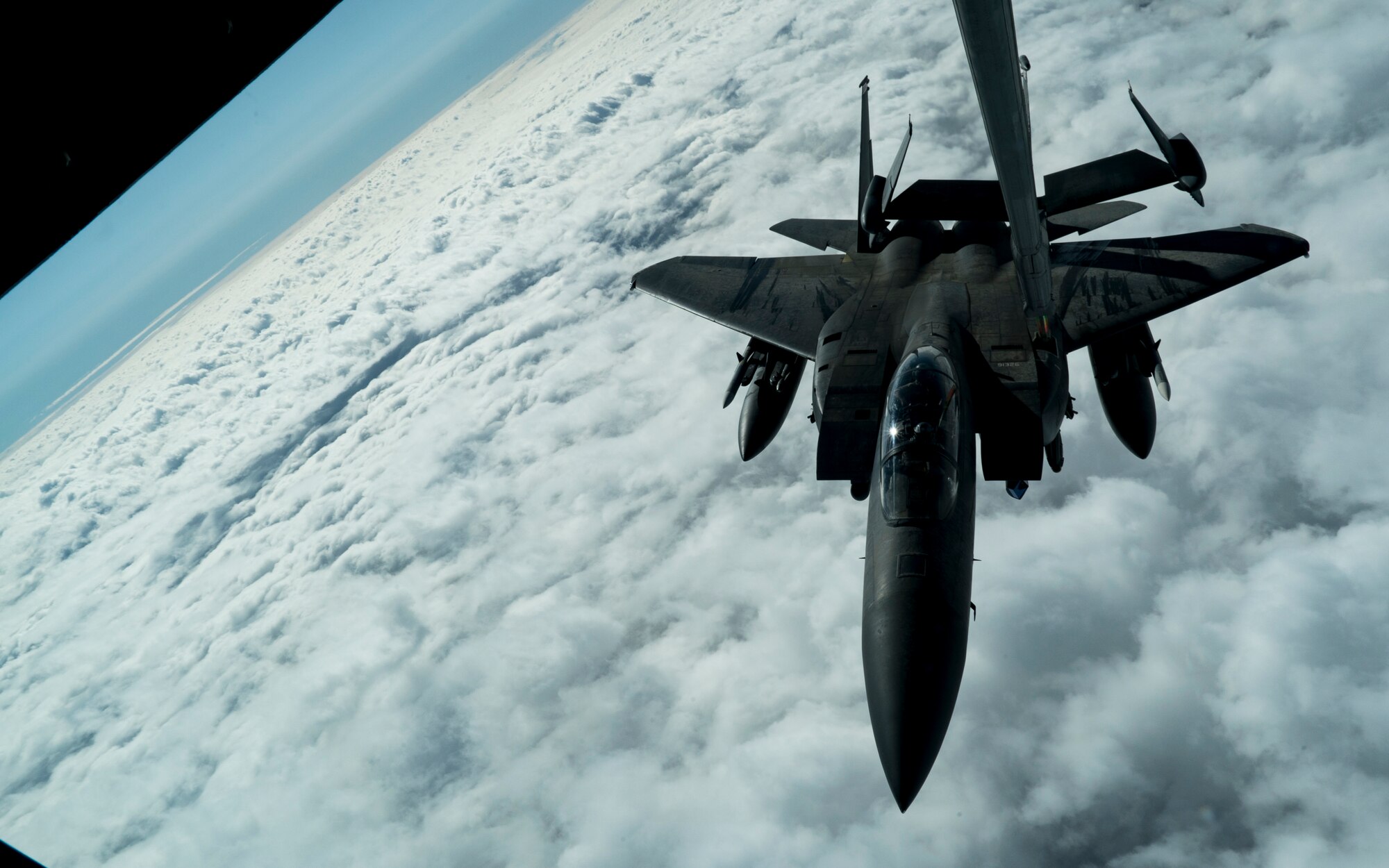 A U.S. Air Force F-15E Strike Eagle aircraft assigned to the 494th Expeditionary Fighter Squadron receives fuel from a KC-10 Extender aircraft assigned to the 908th Expeditionary Air Refueling Squadron over an undisclosed location in support of Air Force Central Command objectives, Jan. 13, 2020.