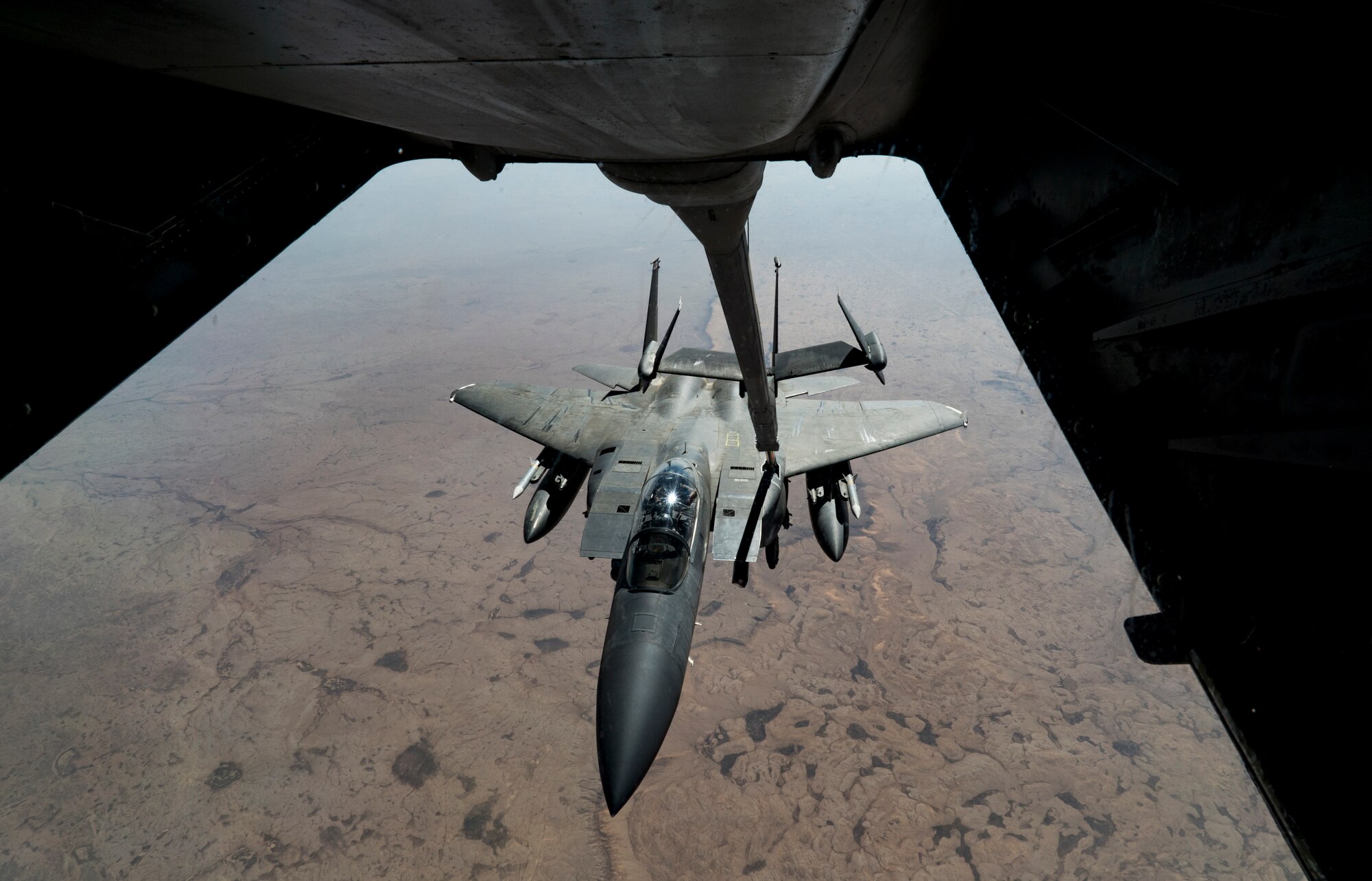 A U.S. Air Force F-15E Strike Eagle aircraft assigned to the 494th Expeditionary Fighter Squadron receives fuel from a KC-10 Extender aircraft assigned to the 908th Expeditionary Air Refueling Squadron over an undisclosed location, Jan. 13, 2020.