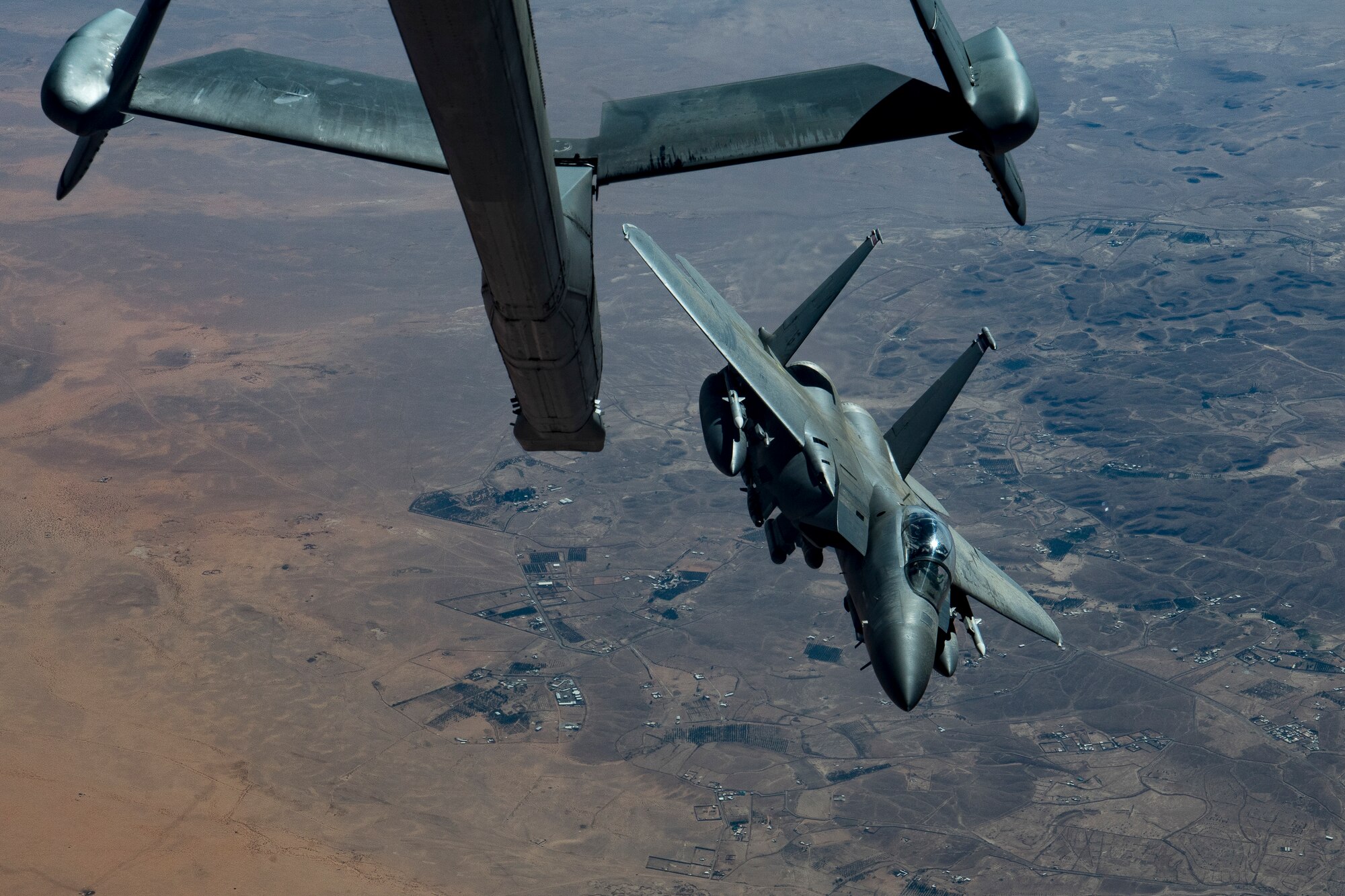 A U.S. Air Force F-15E Strike Eagle assigned to the 494th Expeditionary Fighter Squadron breaks away after being in-air refueled by a KC-10 Extender assigned to the 908th Expeditionary Air Refueling Squadron above the U.S. Central Command area of responsibility, Jan. 13, 2020.