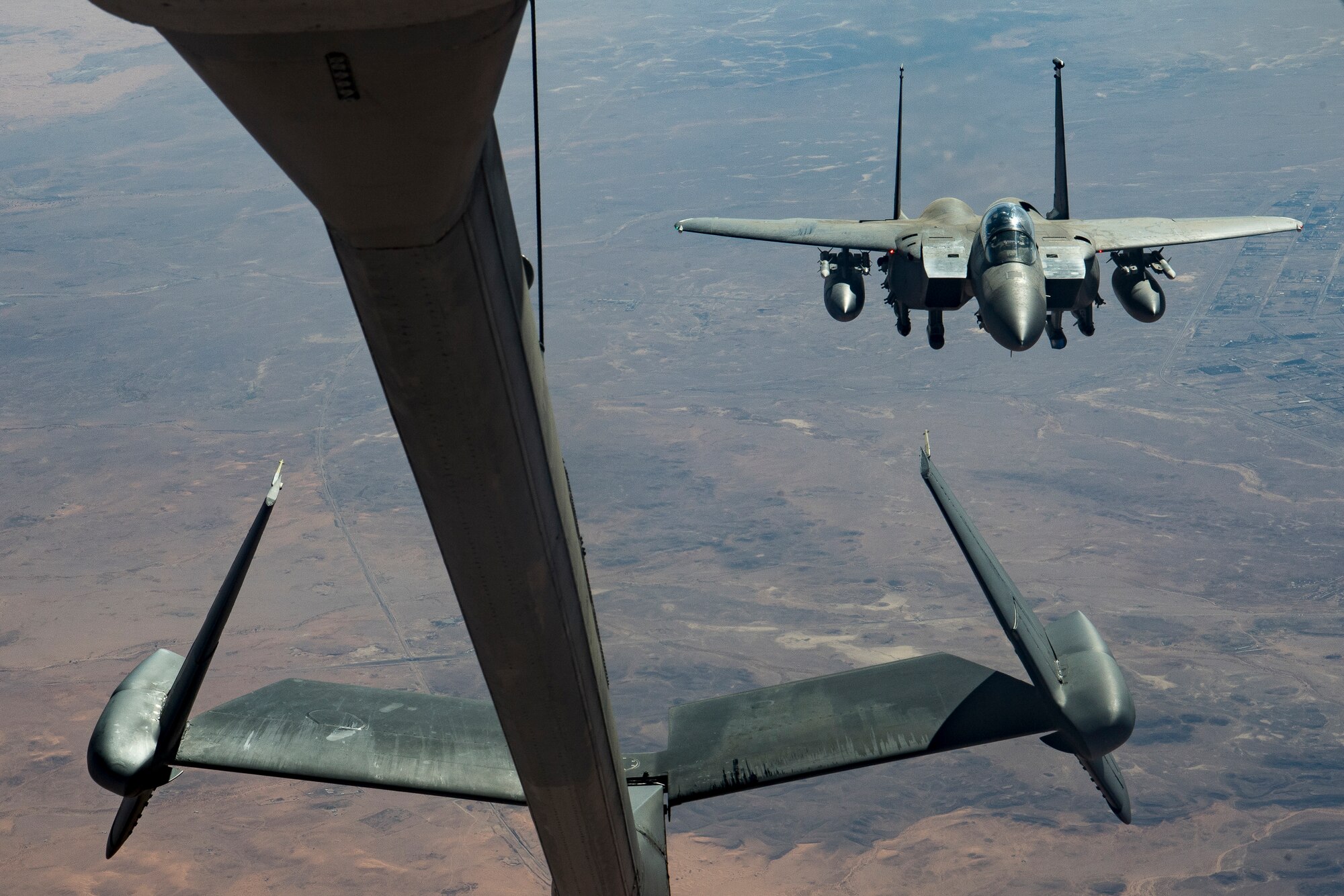 A U.S. Air Force F-15E Strike Eagle assigned to the 494th Expeditionary Fighter Squadron approaches a KC-10 Extender assigned to the 908th Expeditionary Air Refueling Squadron above the U.S. Central Command area of responsibility, Jan. 13, 2020.