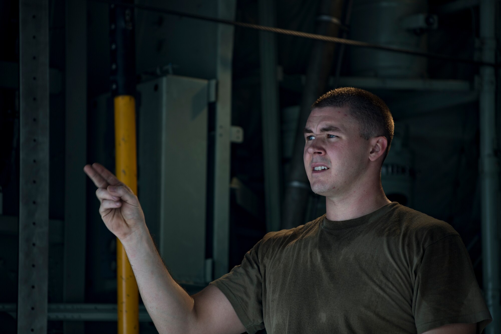 A U.S. Air Force C-130 Hercules loadmaster assigned to the 746th Expeditionary Airlift Squadron directs Airmen at Al Udeid Air Base, Qatar, Dec. 15, 2019.