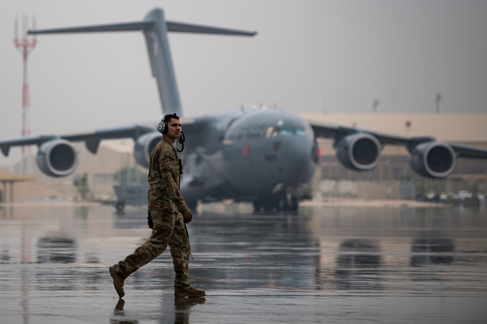 A U.S. Air Force flying crew chief assigned to the 816th Expeditionary Airlift Squadron conducts preflight checks of a U.S. Air Force C-17 Globemaster III at Al Udeid Air Base, Qatar, Jan. 10, 2020.