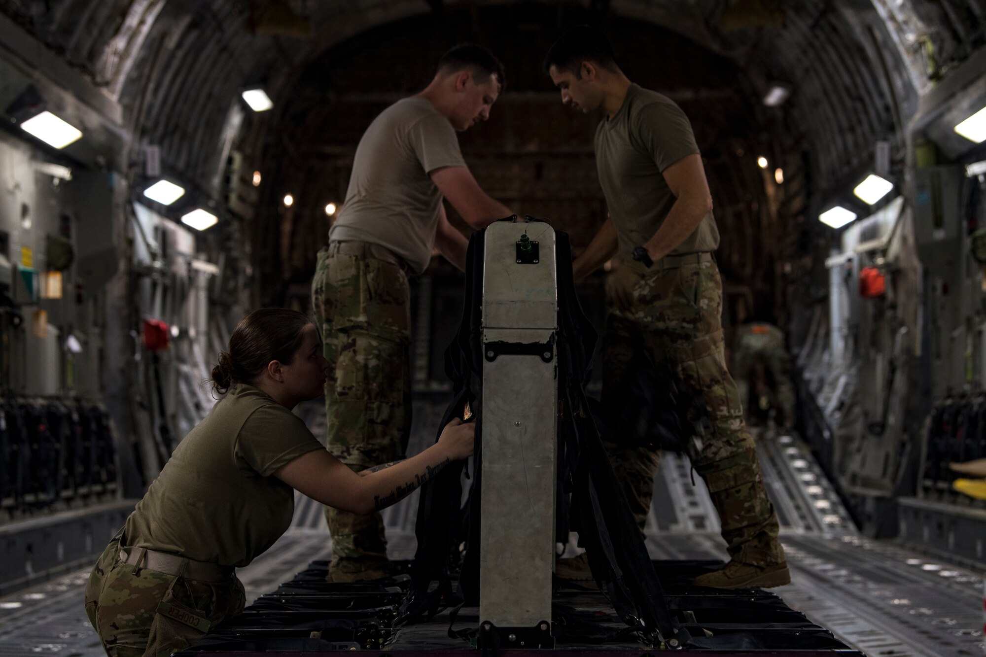 U.S. Air Force Airmen assigned to the 816th Expeditionary Airlift Squadron assemble passenger seats on a U.S. Air Force C-17 Globemaster III at Al Udeid Air Base, Qatar, Jan. 10, 2020.