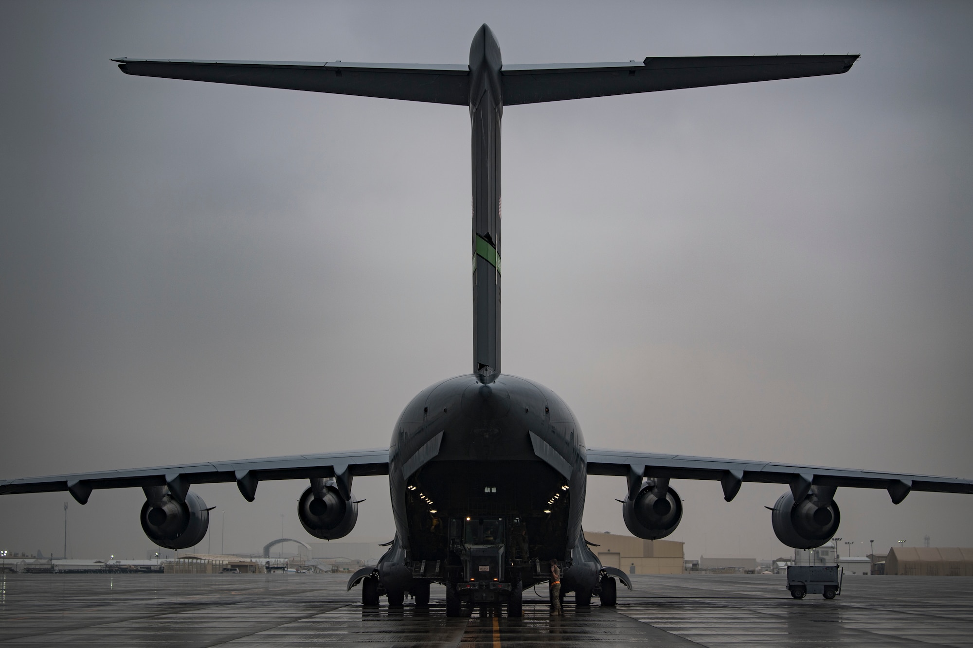 U.S. Air Force Airmen assigned to 746th Expeditionary Logistics Readiness Squadron load cargo into a C-17 Globemaster III assigned to the 816th Expeditionary Airlift Squadron at Al Udeid Air Base, Qatar, Jan. 10, 2020.