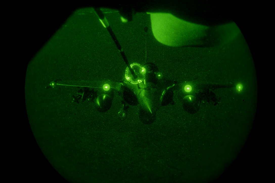 A U.S. Air Force KC-10 Extender boom operator with the 908th Expeditionary Air Refueling Squadron conducts an aerial refueling with a French Air Force Dassault Rafale fighter aircraft in support of Operation Inherent Resolve, Jan. 11, 2020.