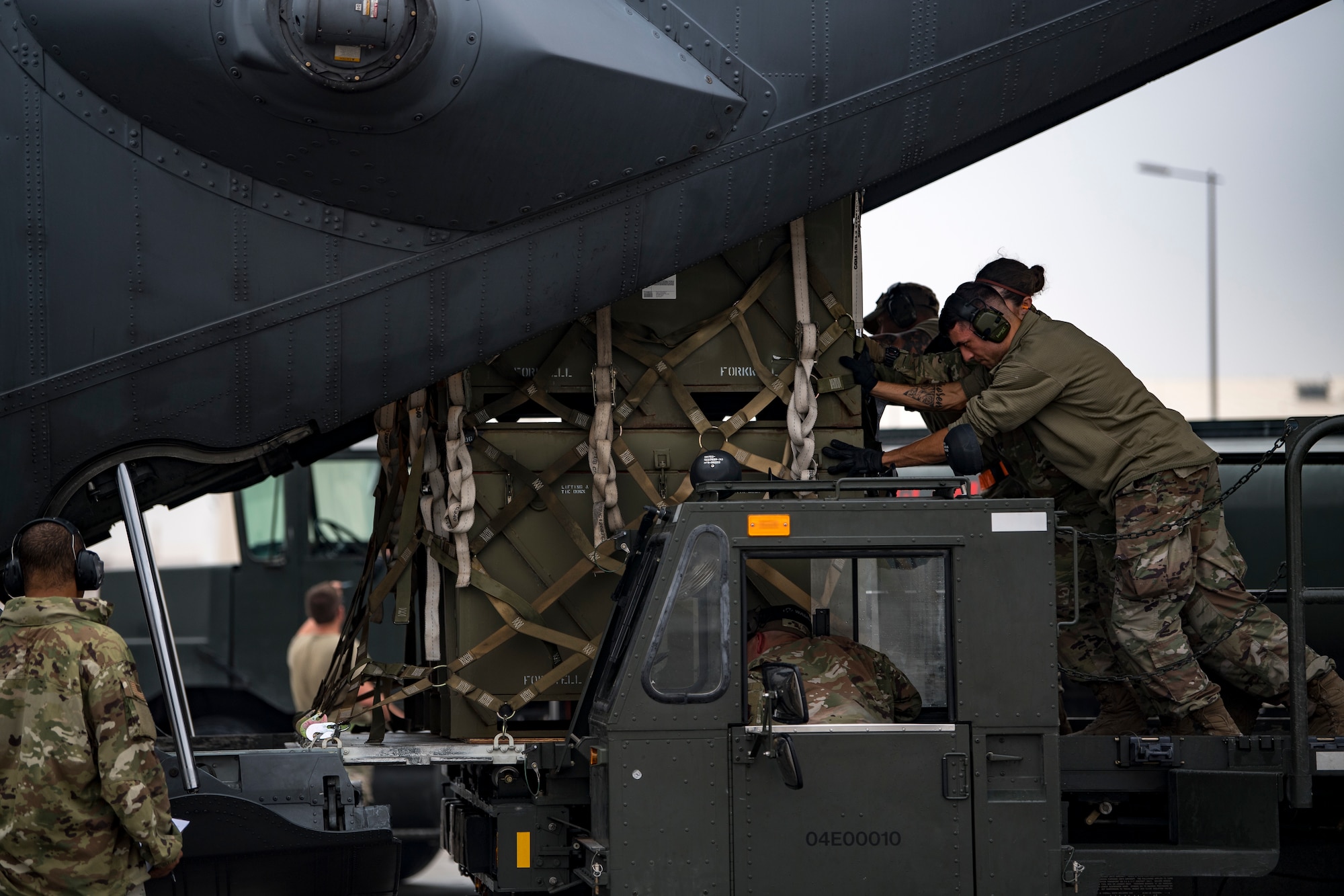 U.S. Air Force Airmen assigned to 746th Expeditionary Logistics Readiness Squadron load cargo into a U.S. Air Force C-130 Hercules assigned to the 746th Expeditionary Airlift Squadron at Al Udeid Air Base, Qatar, Dec. 15, 2019.
