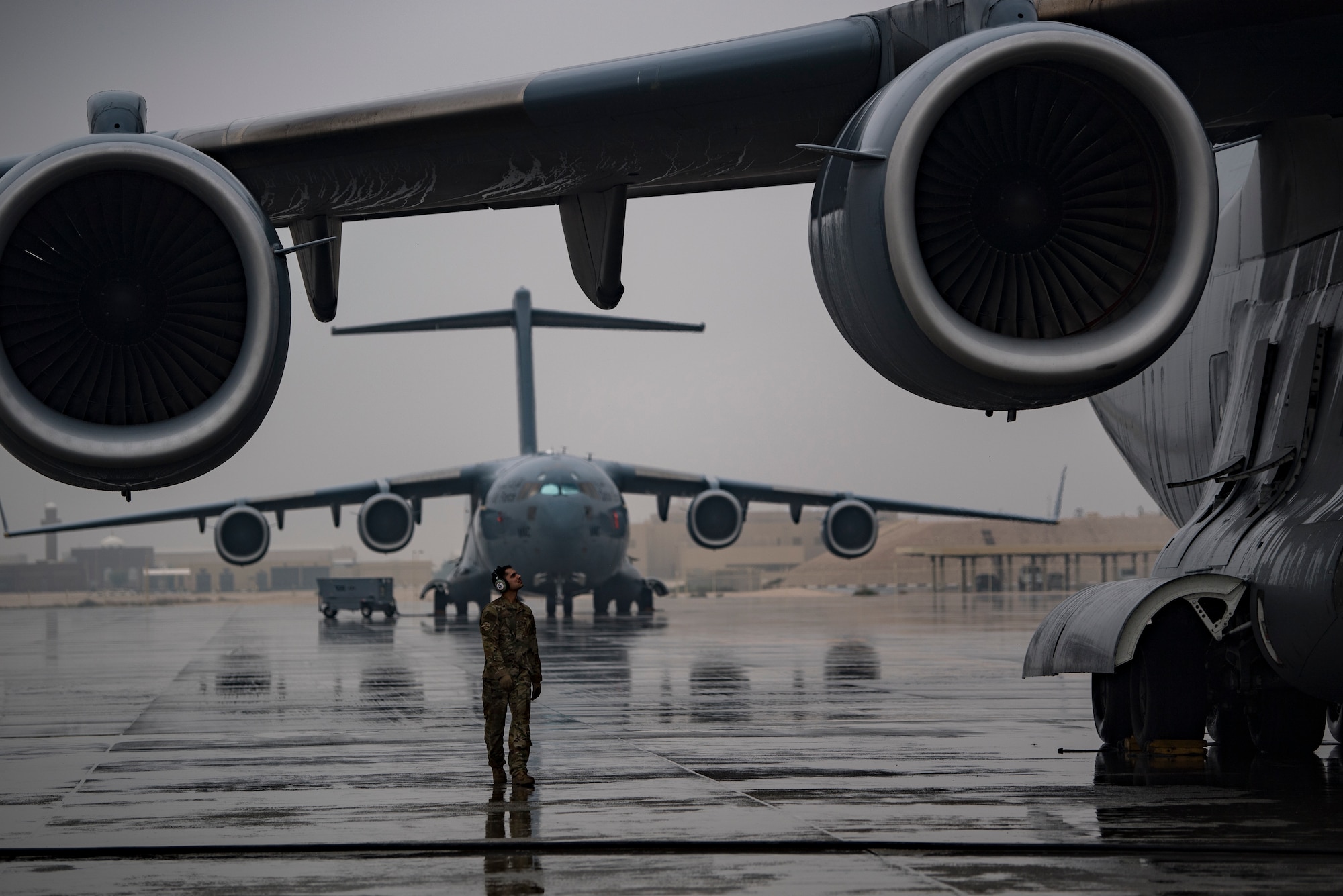 A U.S. Air Force flying crew chief assigned to the 816th Expeditionary Airlift Squadron conducts preflight checks of a U.S. Air Force C-17 Globemaster III at Al Udeid Air Base, Qatar, Jan. 10, 2020.