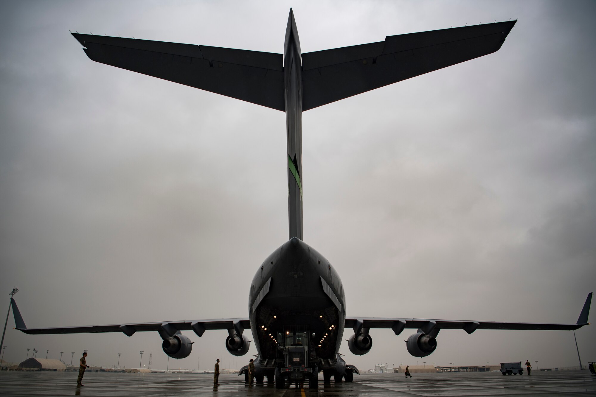 U.S. Air Force Airmen assigned to 746th Expeditionary Logistics Readiness Squadron load cargo into a C-17 Globemaster III assigned to the 816th Expeditionary Airlift Squadron at Al Udeid Air Base, Qatar, Jan. 10, 2020.
