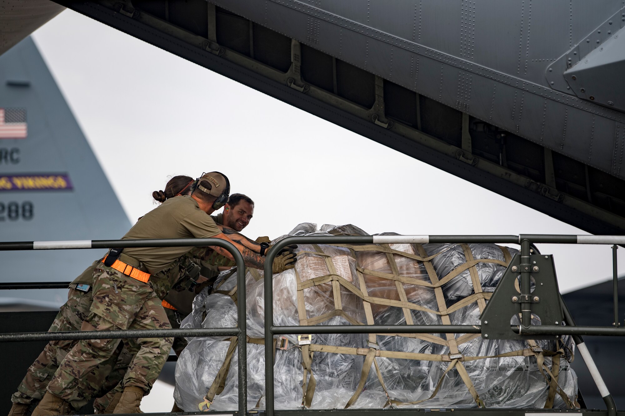 U.S. Air Force Airmen assigned to the 746th Expeditionary Logistics Readiness Squadron load cargo into a U.S. Air Force C-130 Hercules assigned to the 746th Expeditionary Airlift Squadron at Al Udeid Air Base, Qatar, Dec. 15, 2019.