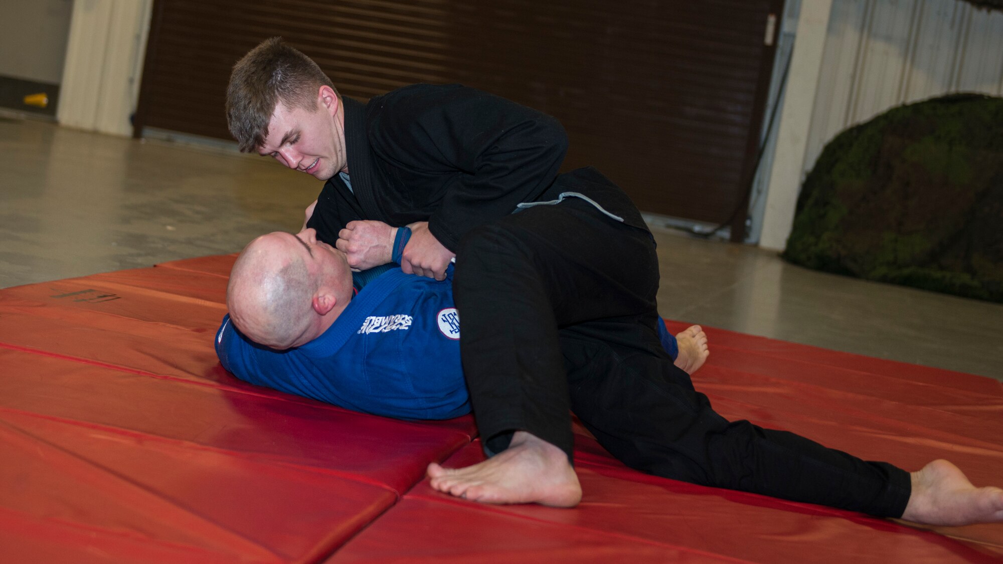 Staff Sgt. Chad Jarvis (right), 103rd Security Forces Squadron defender, grapples with Tech. Sgt. Michael Stearns, 103rd Security Forces Squadron combat arms noncommissioned officer in charge, during a jiu-jitsu session at Bradley Air National Guard Base, East Granby, Conn. Jan. 23, 2020. The two are part of a group of Security Forces members that meets throughout the month during their physical training time to practice jiu-jitsu, building camaraderie between the members while utilizing combatives skills and outside experience in the martial art. (U.S. Air National Guard photo by Staff Sgt. Steven Tucker)