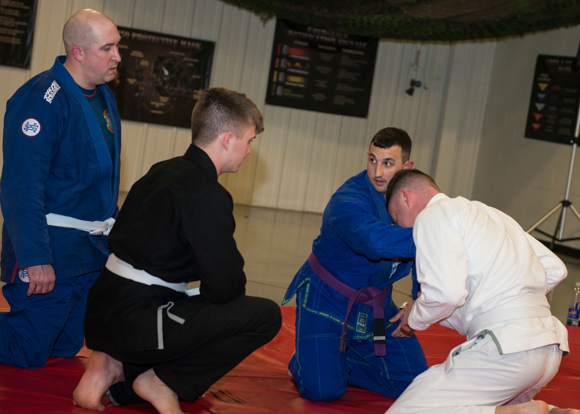 Master Sgt. Ian McMahon (second from right), 103rd Security Forces Squadron flight chief and combatives instructor, teaches a maneuver during an informal jiu-jitsu session at Bradley Air National Guard Base, East Granby, Conn. Jan. 23, 2020. The group of Security Forces members meets throughout the month during their physical training time to practice jiu-jitsu, building camaraderie between the members while utilizing combatives skills and outside experience in the martial art. (U.S. Air National Guard photo by Staff Sgt. Steven Tucker)