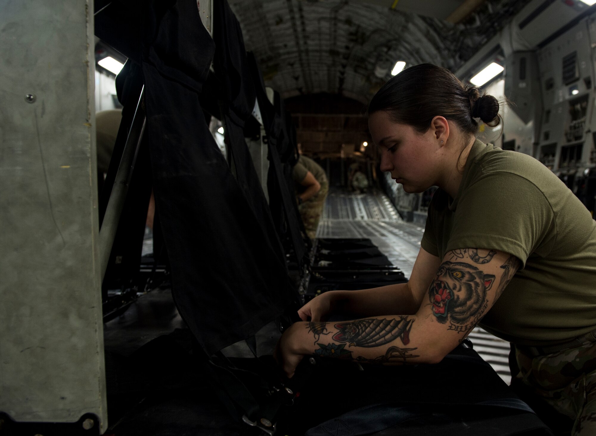A U.S. Air Force loadmaster assigned to the 816th Expeditionary Airlift Squadron assembles passenger seats on a U.S. Air Force C-17 Globemaster III at Al Udeid Air Base, Qatar, Jan. 10, 2020.