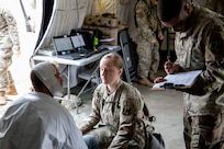 U.S. Army 1st Lt. Kelsey Shimanck and U.S. Army Spc. Dashawn Bandy, both assigned to the 546th Area Support Medical Company (ASMC), evaluate a simulated disaster victim during a medical decontamination line evolution at the Travis County Expo Center as part of Exercise Sudden Response (SR) 20.