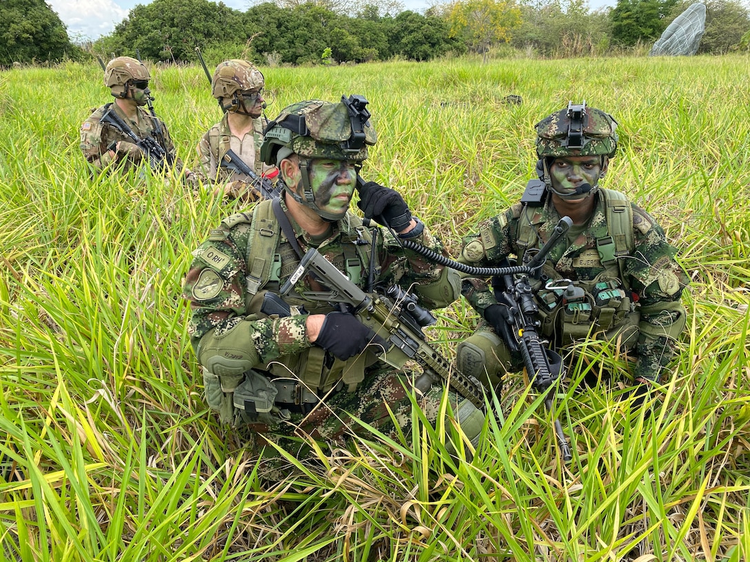 Paratroopers assigned to the 82nd Airborne Division alongside their Colombian secure a drop zone.