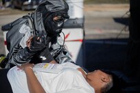 U.S. Army Pfc. Aryanna Tate, assigned to 546th Area Support Medical Company comforts a role player in a simulated decontamination line at Travis County Exposition Center as part of Exercise Sudden Response 20.