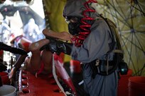 U.S. Army Pvt. Aidan Barker, assigned to the 87th Sapper Engineer Company, rinses a mannequin to train for mass casualty decontamination at Travis County Exposition Center as part of Exercise Sudden Response 20.