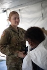 U.S. Army Pvt. Kayle Johns, assigned to 546th Area Support Medical Company assists a patient role-player in a simulated mass casualty decontamination line tent at Travis County Exposition Center as part of Exercise Sudden Response 20.