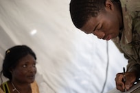 U.S. Army Pfc. Timothy Thomas, assigned to 546th Area Support Medical Company writes status notes on role player in a simulated mass casualty decontamination line at Travis County Exposition Center, Austin, Texas, as part of Exercise Sudden Response 20.