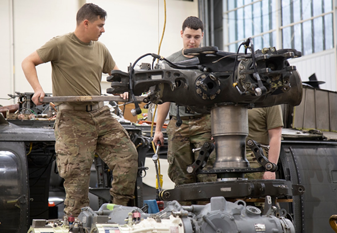 Army Maintainers repair rotor spindle assemblies on aircraft