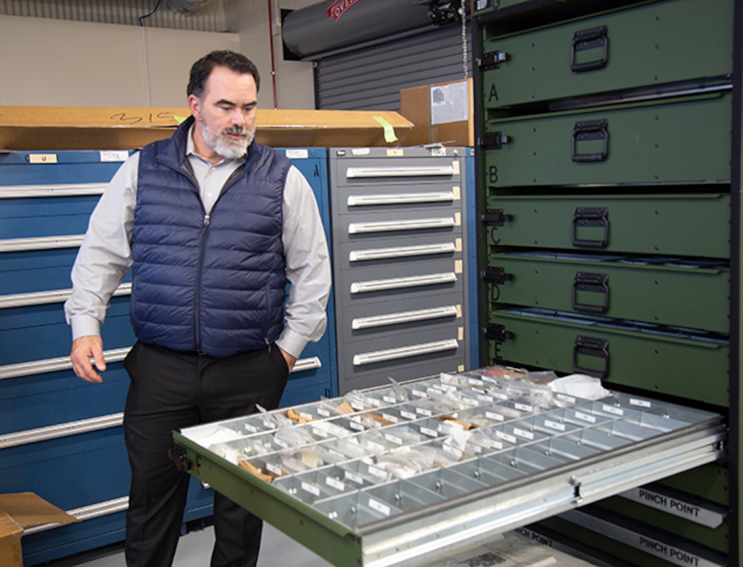 DLA Aviation customer account specialist looks into a container system drawer at a Black Hawk maintenance inspection kit