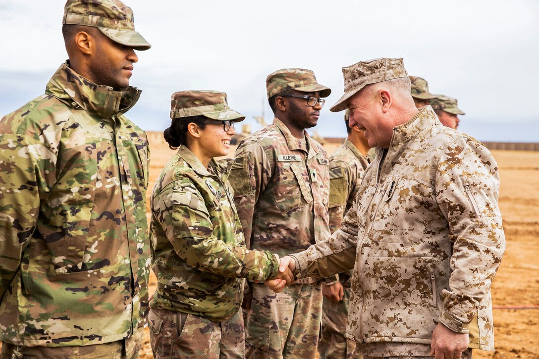 U.S. Marine Corps Gen. Kenneth F. McKenzie Jr., the commander of U.S. Central Command, right, shakes hands with a Soldier assigned to 3rd Battalion, 4th Air Defense Artillery Regiment, Jan. 24, 2020. McKenzie visited the USCENTCOM Area of Responsibility to discuss security and stability in the region with forward deployed service members. (U.S. Marine Corps photo by Sgt. Roderick Jacquote)