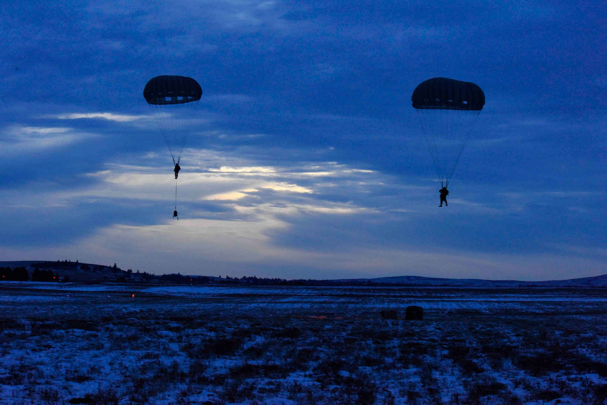 SERE Airmen drop from aircraft