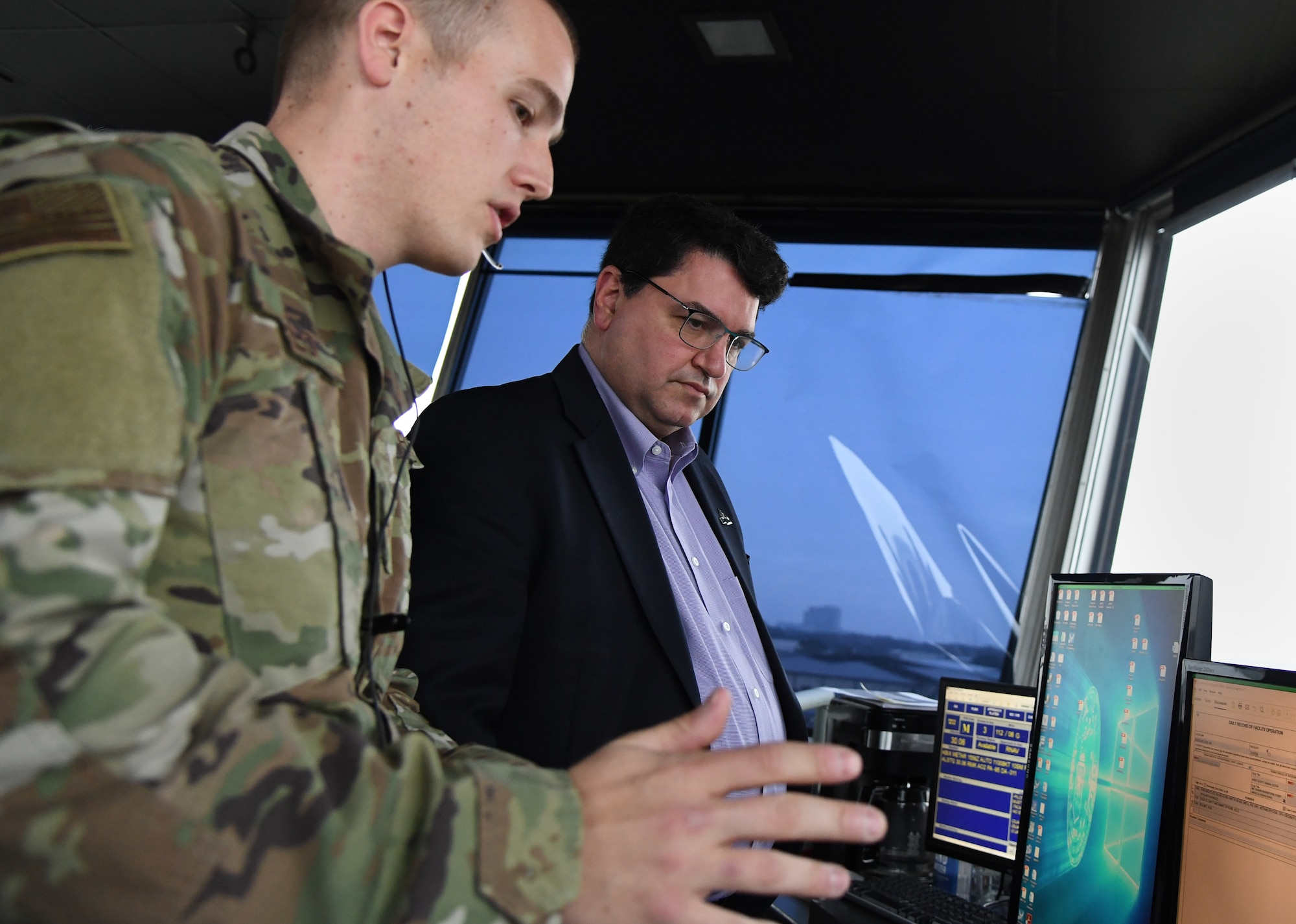 U.S. Air Force Staff Sgt. Andrew Abreo, 81st Operations Support Flight air traffic controller, reviews air traffic control tower support details to Peter Abide, Biloxi city attorney, inside Cody Hall at Keesler Air Force Base, Mississippi, Jan. 23, 2020. Keesler hosted the community engagement for civic leaders to discuss Keesler's flying mission requirements in order to create processes which inform key decision makers regarding local development, and to ensure compatible economic growth for the surrounding communities. (U.S. Air Force photo by Kemberly Groue)